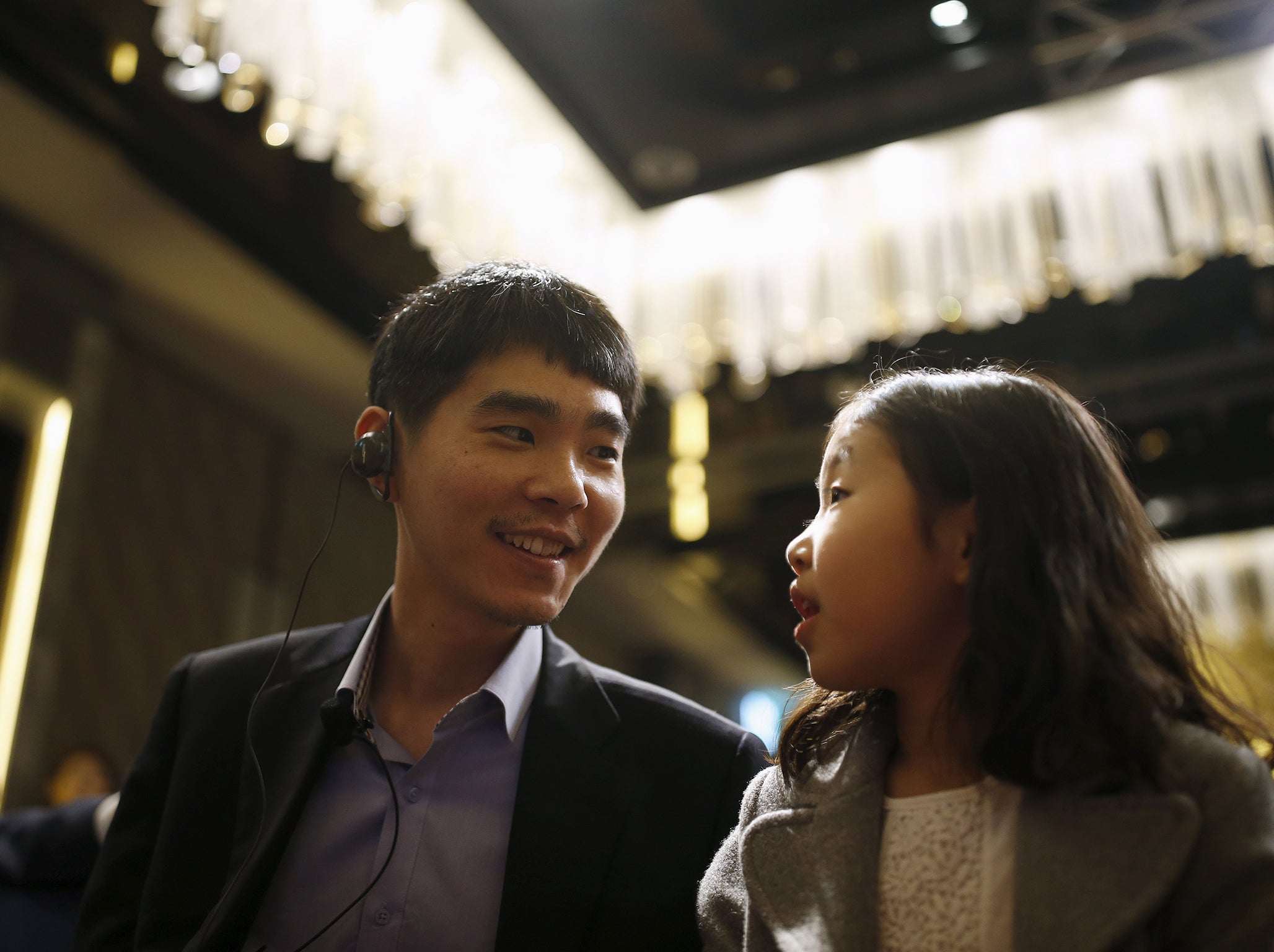 South Korea’s Lee Sedol, the world’s top Go player, talks with his daughter during a news conference ahead of matches against Google’s artificial intelligence program AlphaGo, in Seoul, South Korea, March 8, 2016