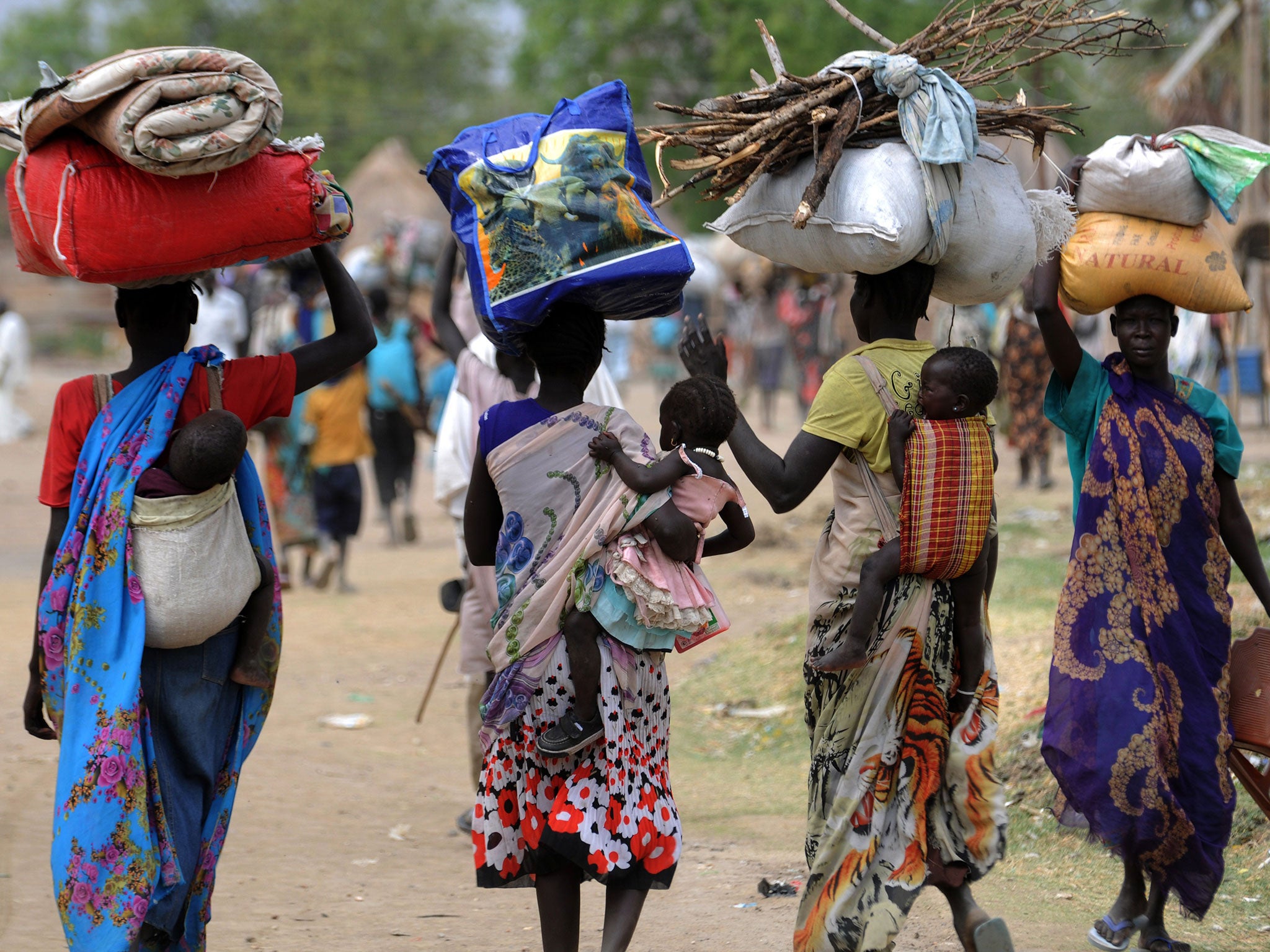 Displaced South Sudanese women walk towards the United Nations Mission in South Sudan (UNMISS) base in Malakal on January 12, 2014.