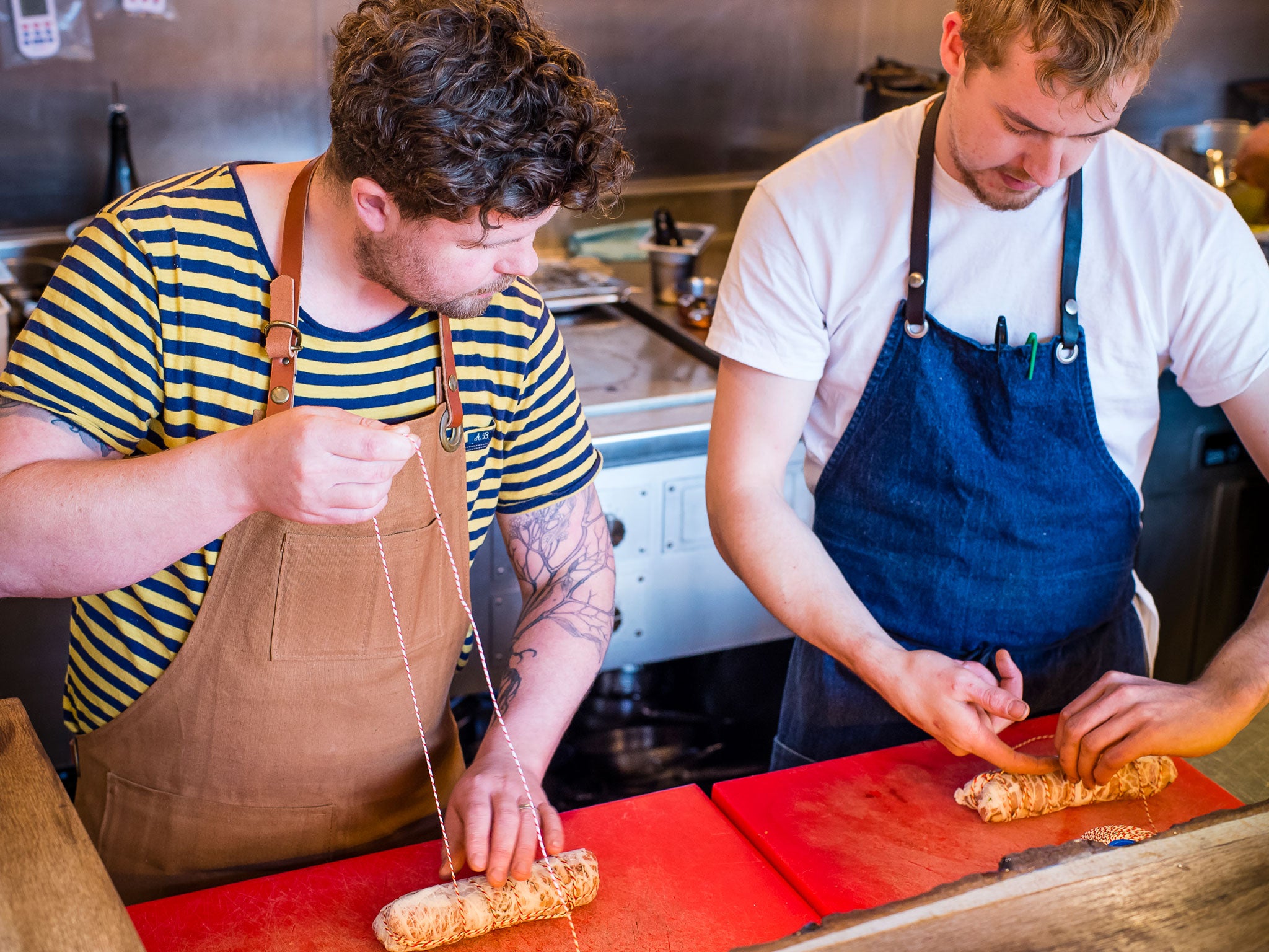 Robin and Simon tying the caul fat around the pancetta and saddle