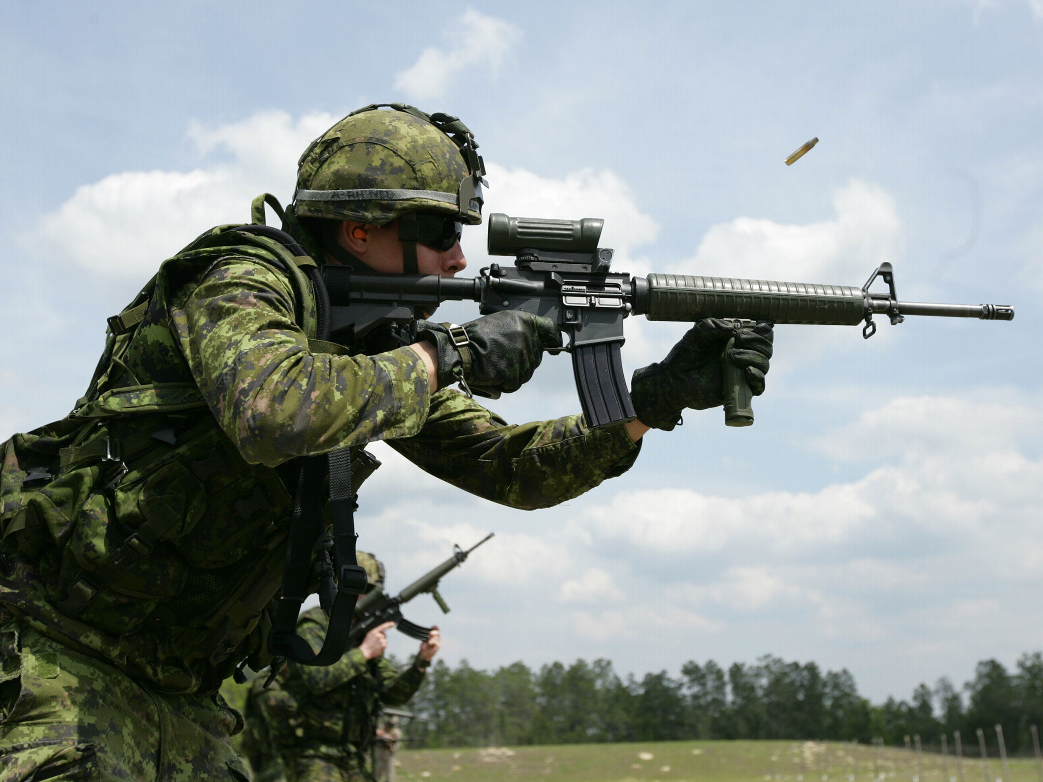 A soldier fires a Colt C7A2, similar to the C8