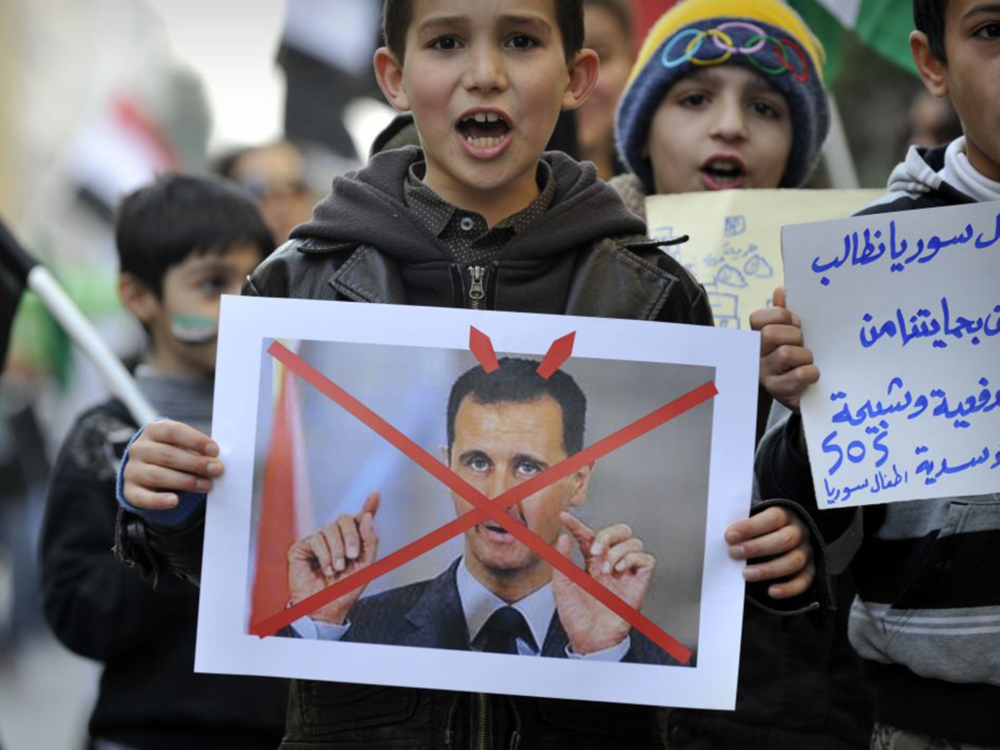 Syrian children living in Greece take part in a demonstration against President Bashar al-Assad in Athens in 2012, to mark the first anniversary of the anti-regime revolt