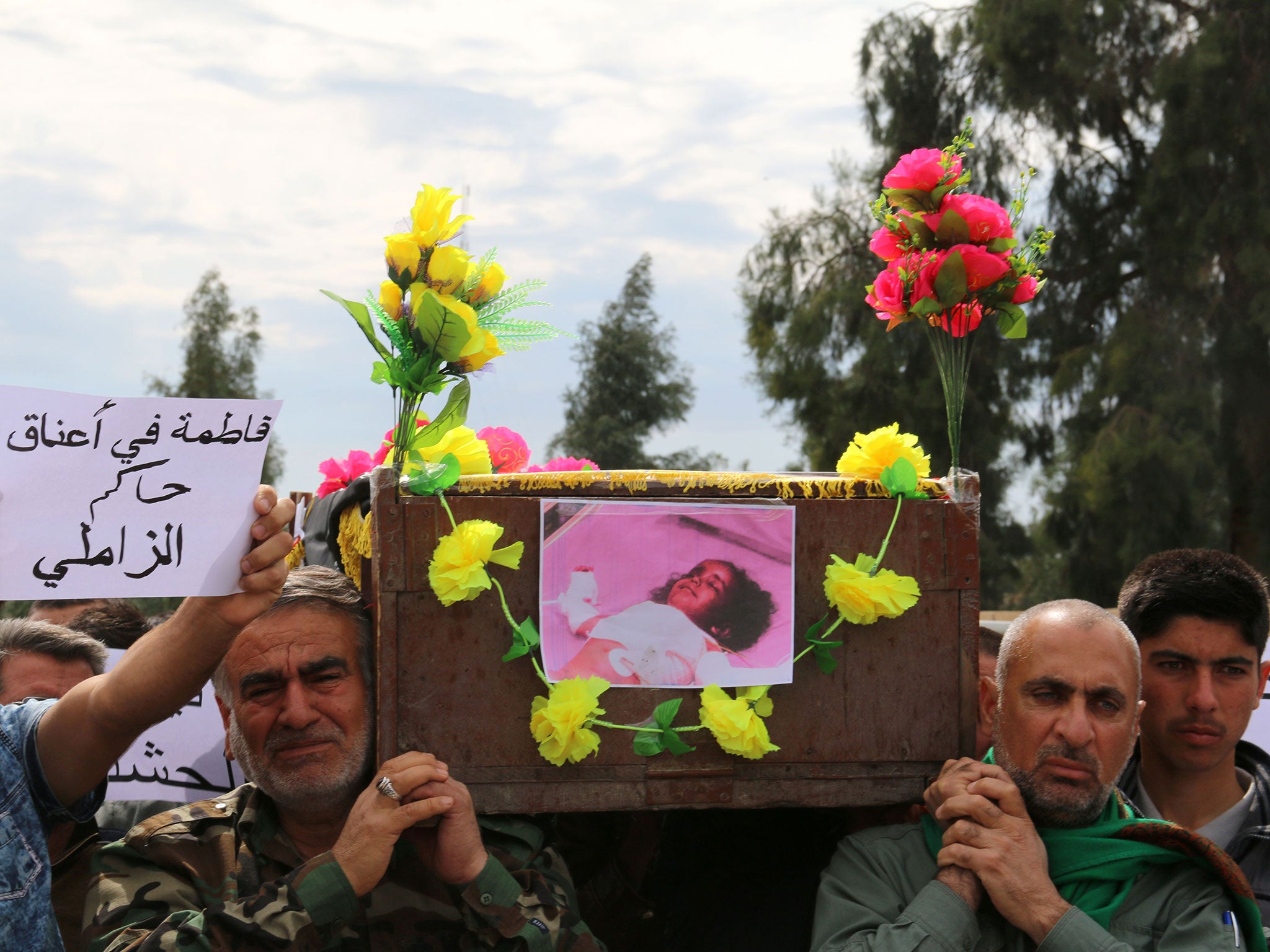 Iraqi Sameer Wais (R) carries the coffin of his three-year-old daughter, Fatima (Marwan Ibrahim/AFP/Getty Images)