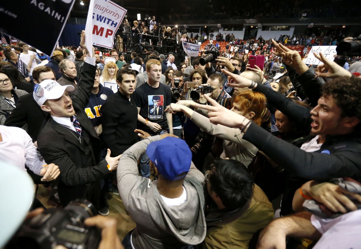 Supporters of Republican presidential candidate Donald Trump, left, face off with protesters in Chicago.