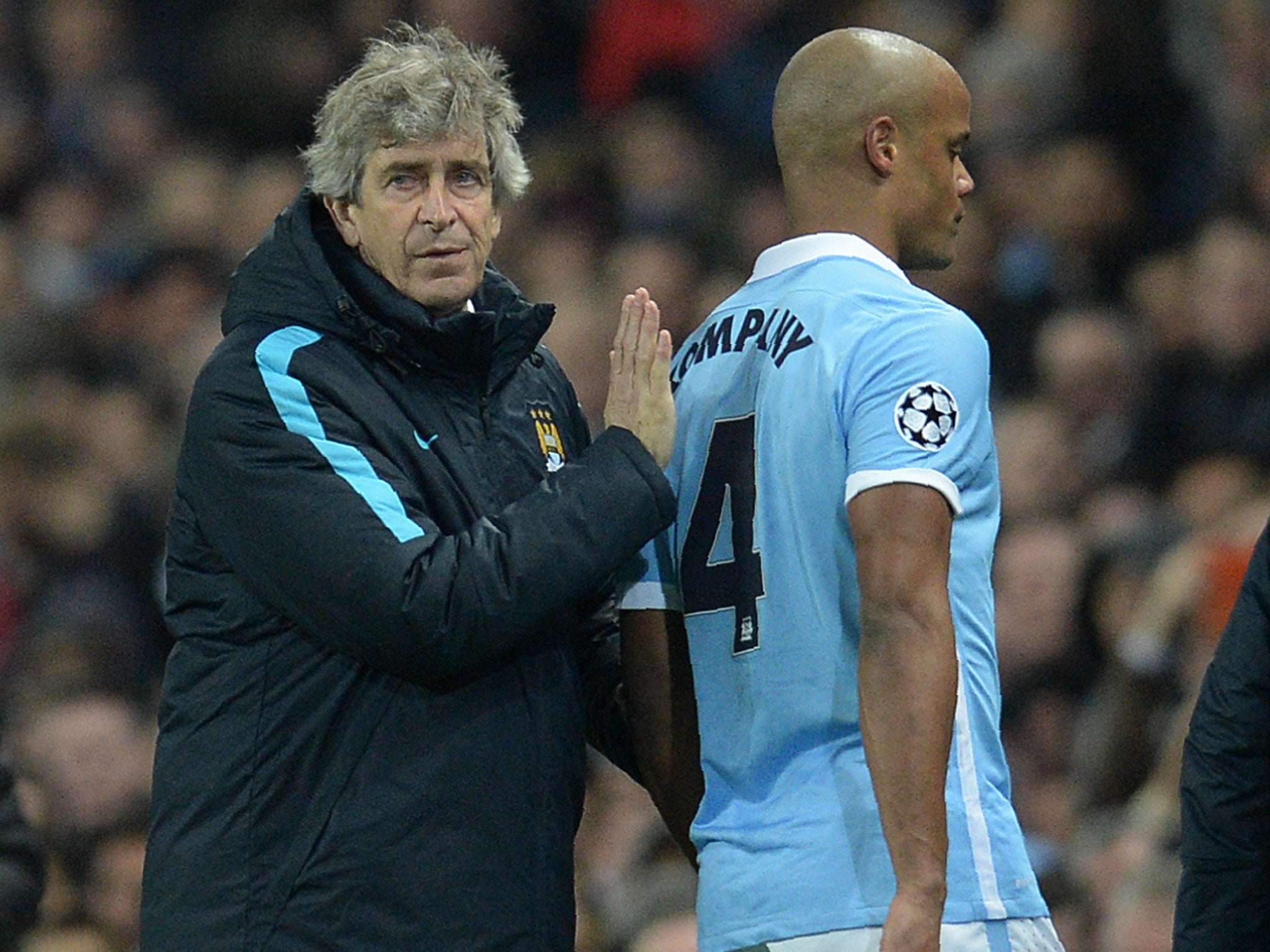 Pellegrini helps Kompany towards the touchline