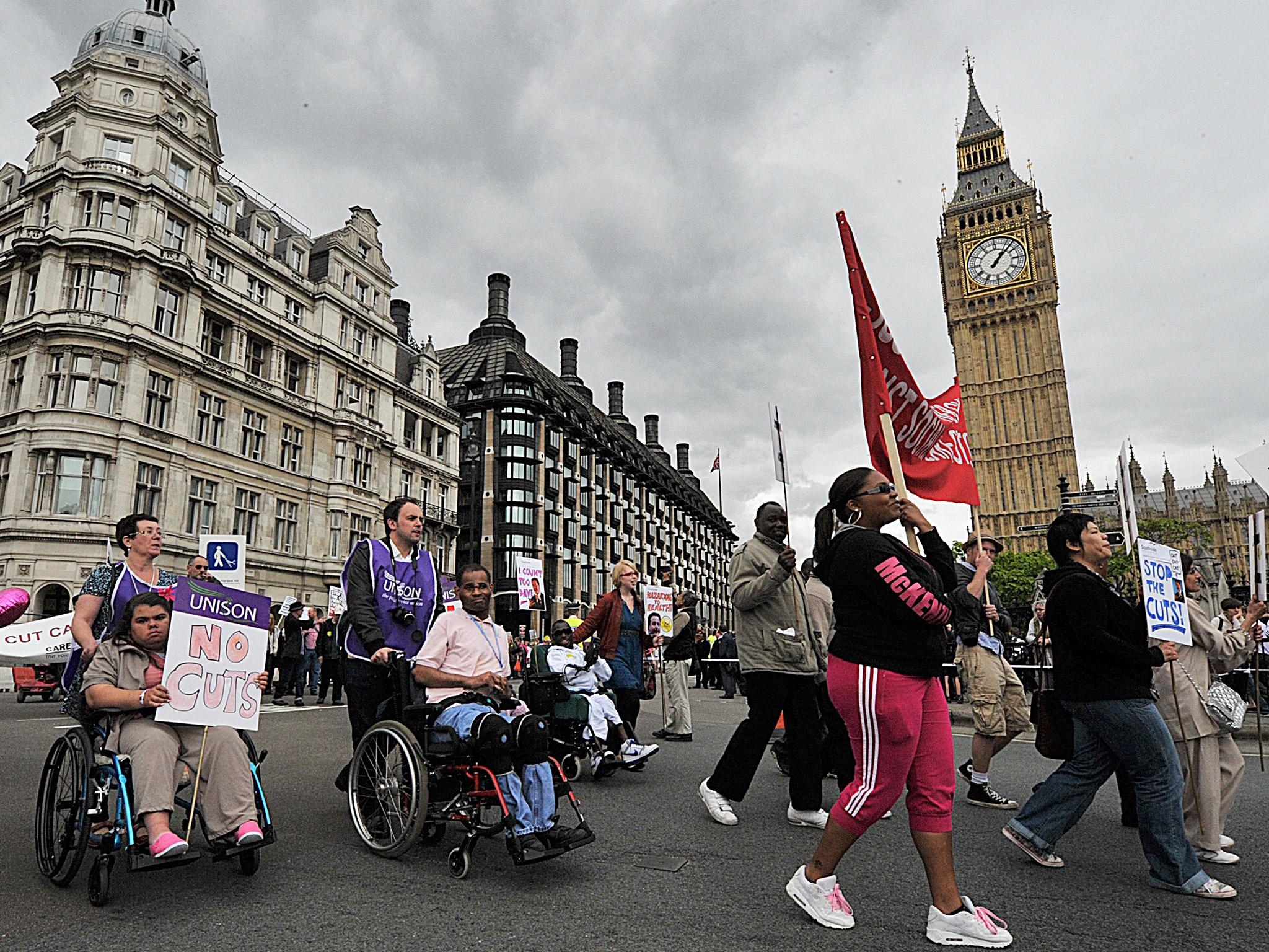 Disabled protestors demonstrate past the Houses of Parliament, in central London (Getty Images)