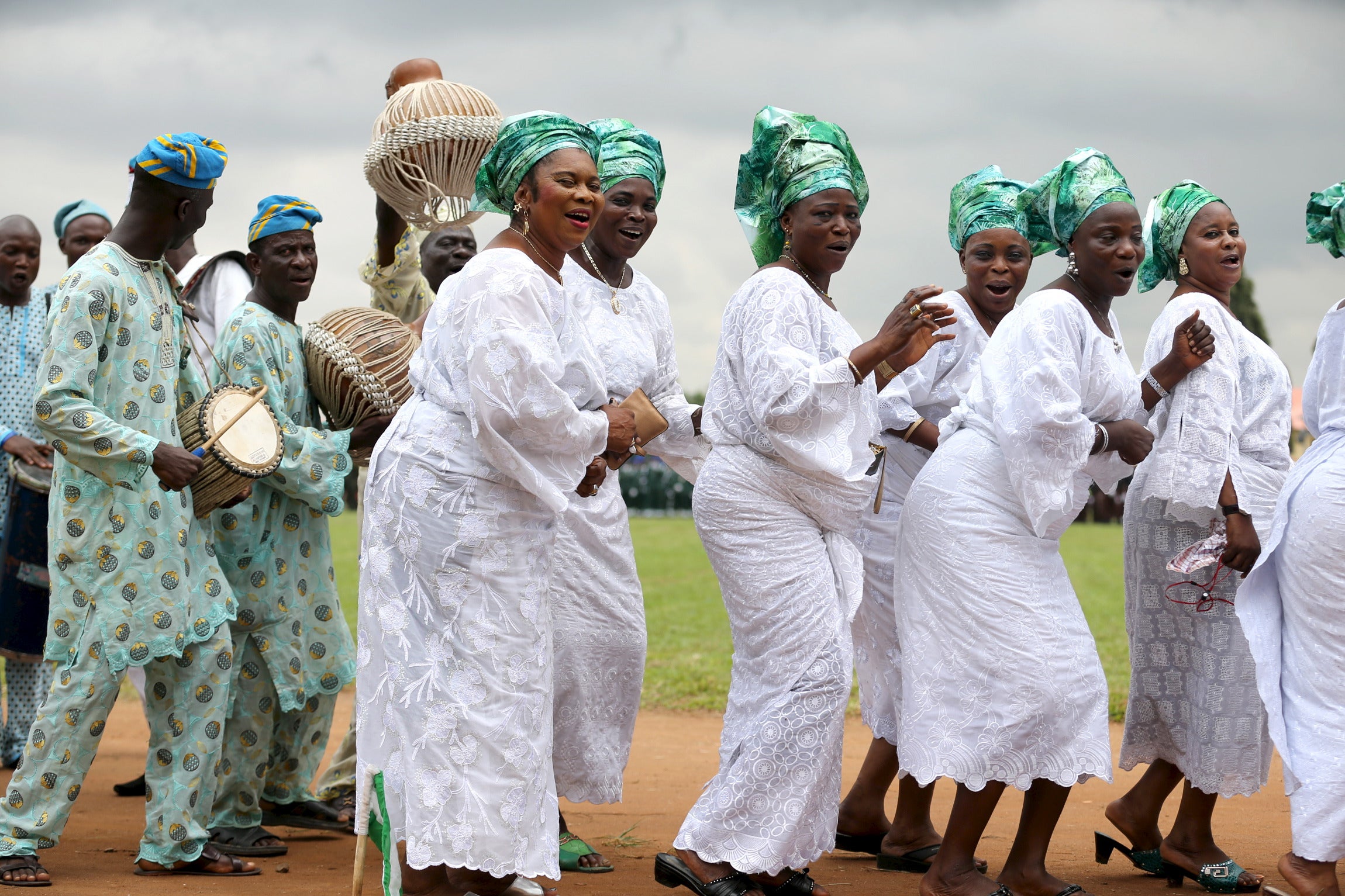 Women dressed in traditional attire sing as they participate in a parade to commemorate Nigeria's 55th Independence Day in Lagos