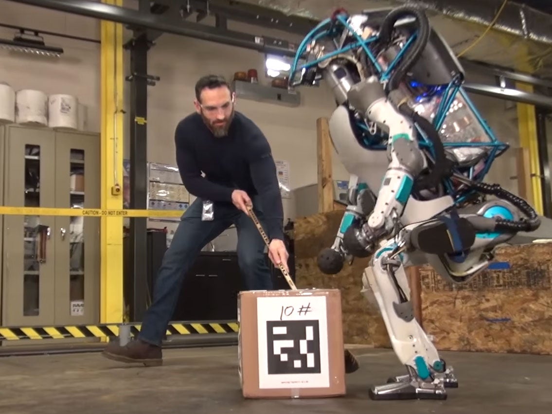 A Boston Dynamics employee torments an Atlas robot in one of the company's videos