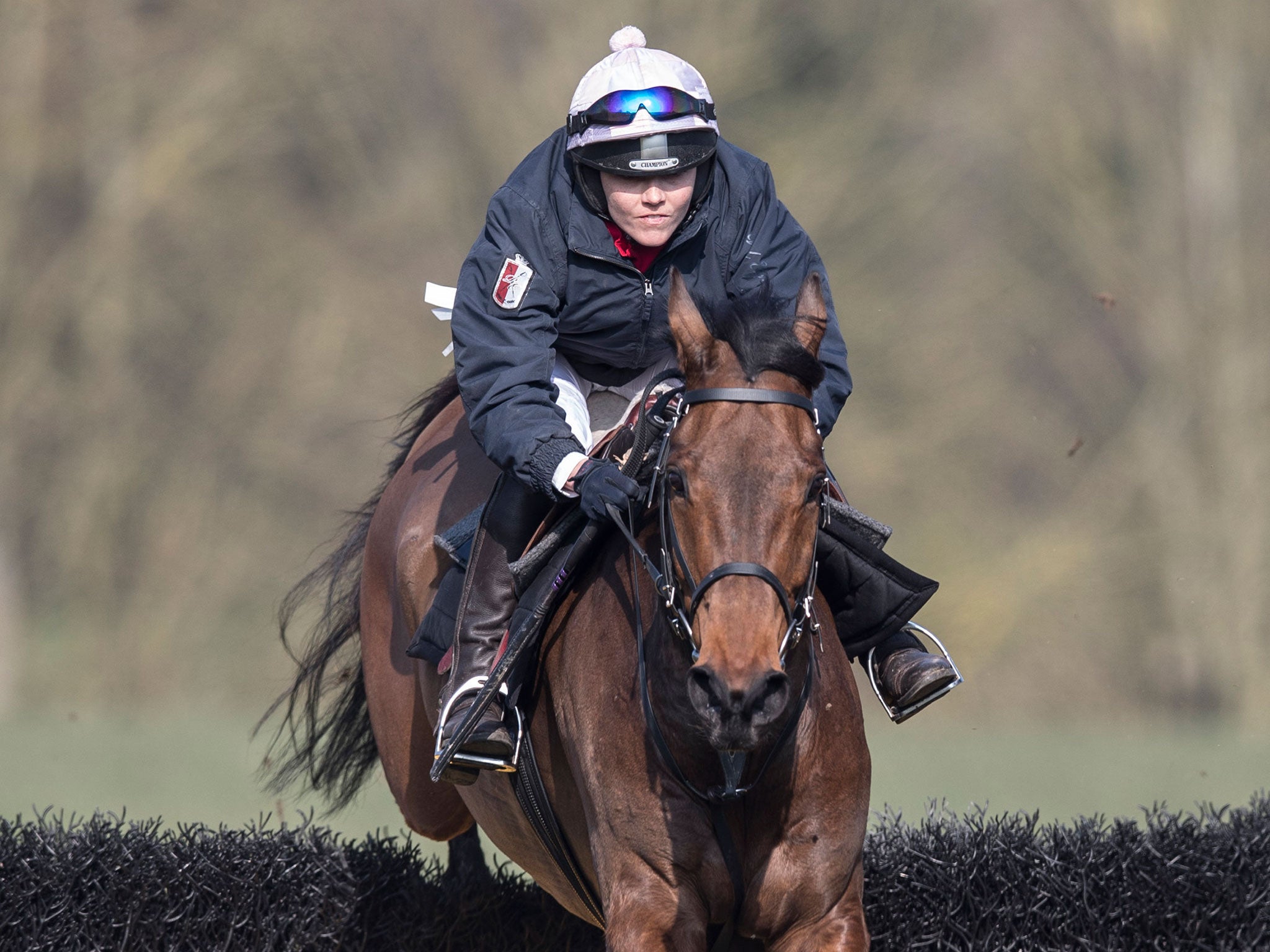 Victoria Pendleton on Minella Theatre clears a jump on the gallops at Aston Rowant in Oxfordshire