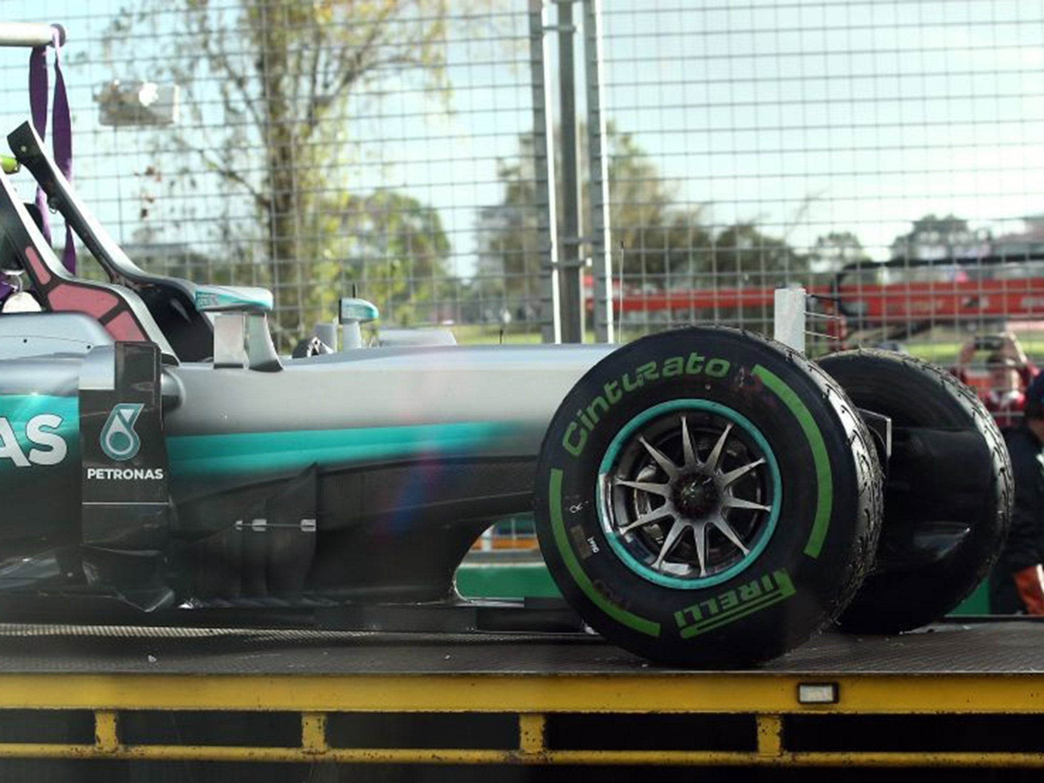 Nico Rosberg's damaged Mercedes is returned to the pits