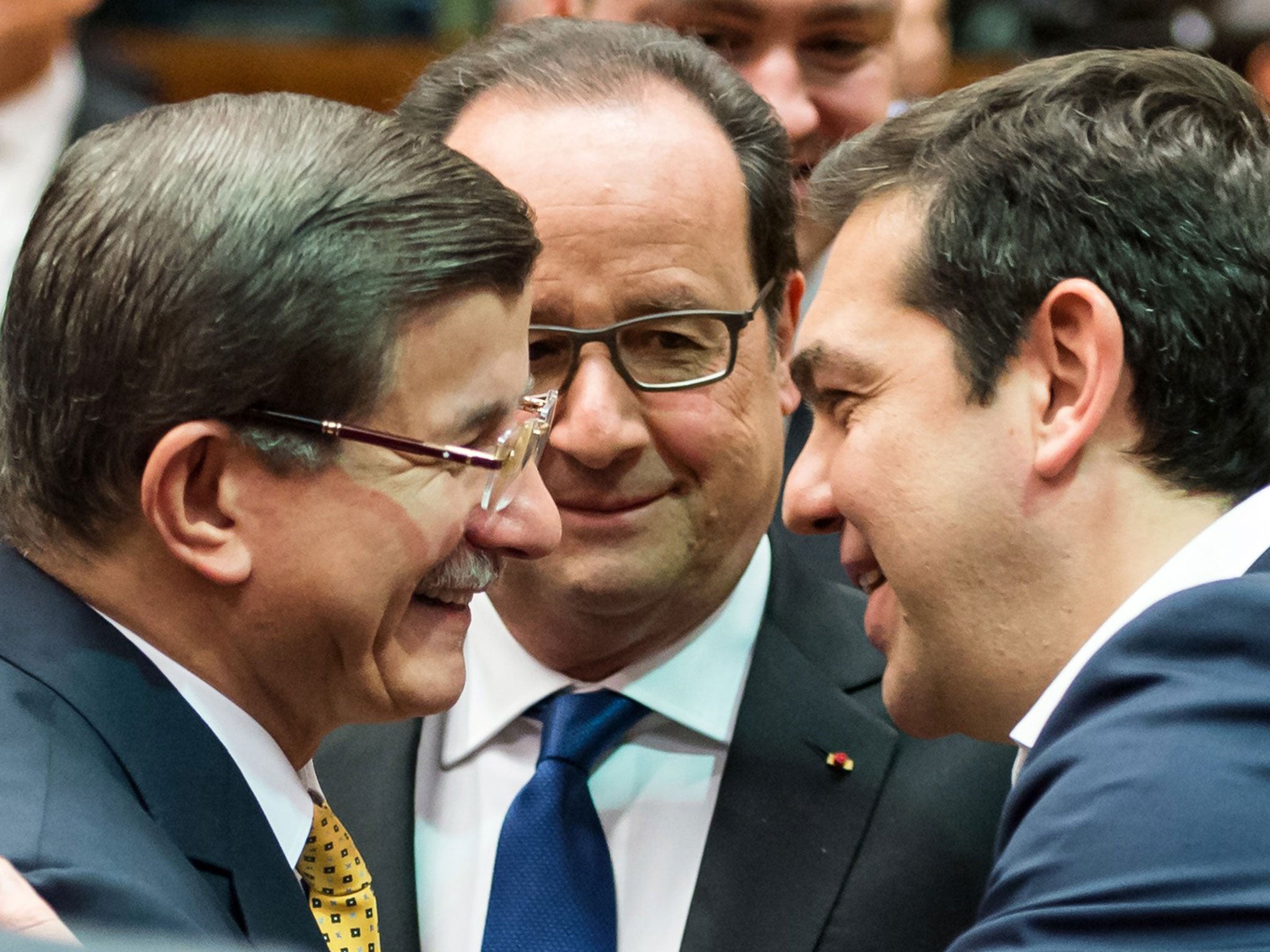 Ahmet Davutoglu, Francois Hollande and Alexis Tsipras at the Brussels summit