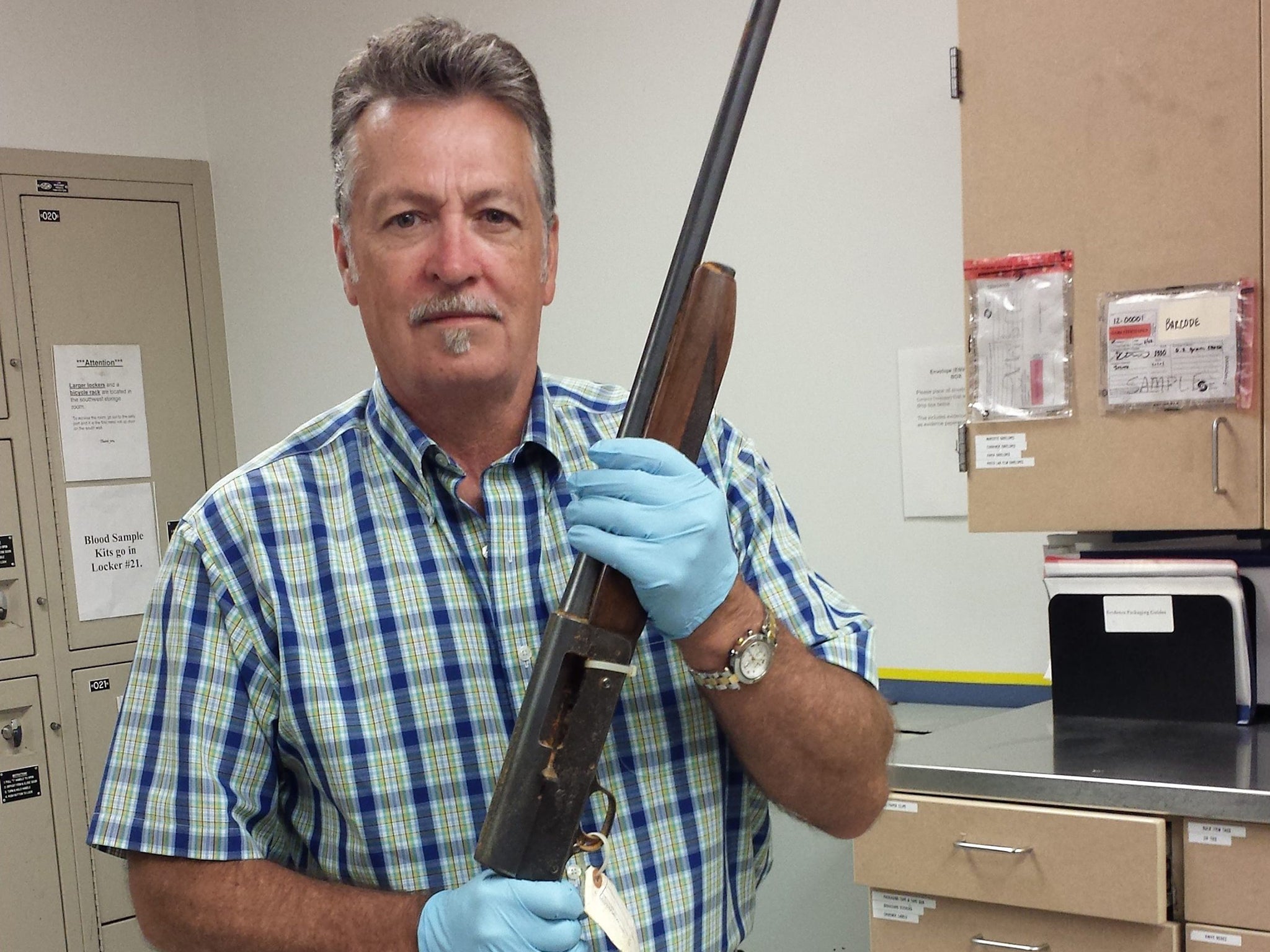 Detective Mike Ciesynski holding the shotgun that Kurt Cobain is alleged to have used to commit suicide. Kurt Cobain's body was found at his Seattle home on 08 April 1994. His death was ruled a suicide by investigators.