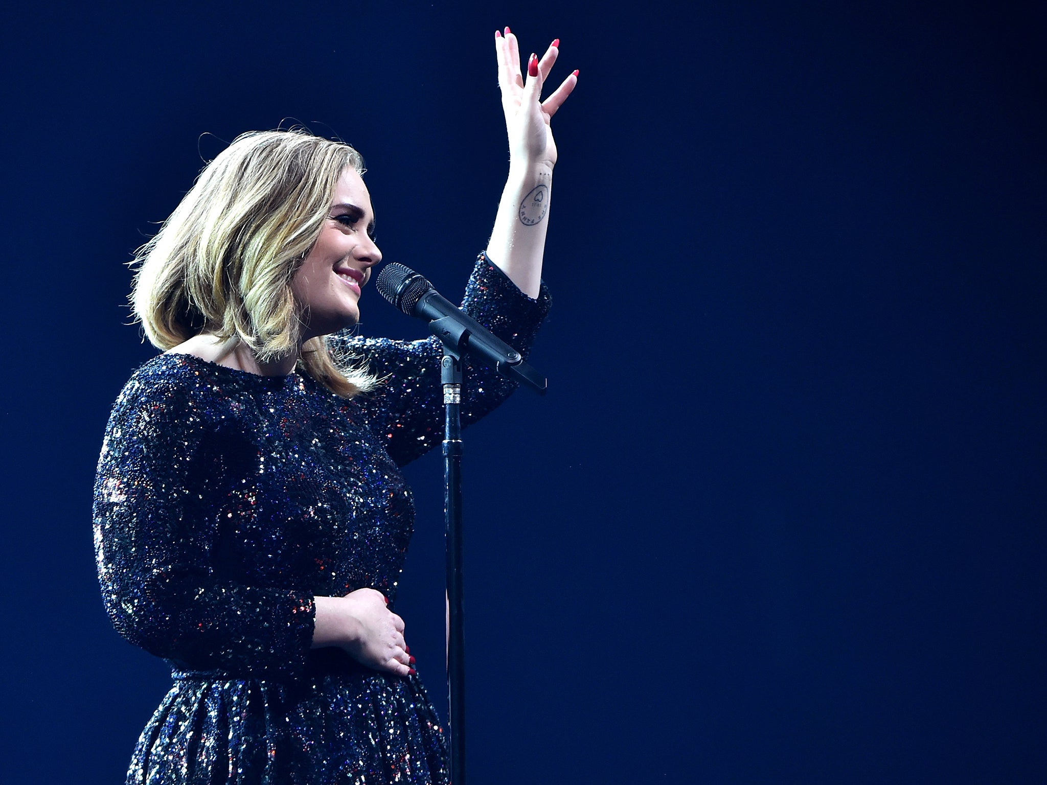 Adele performs on stage at The O2 Arena