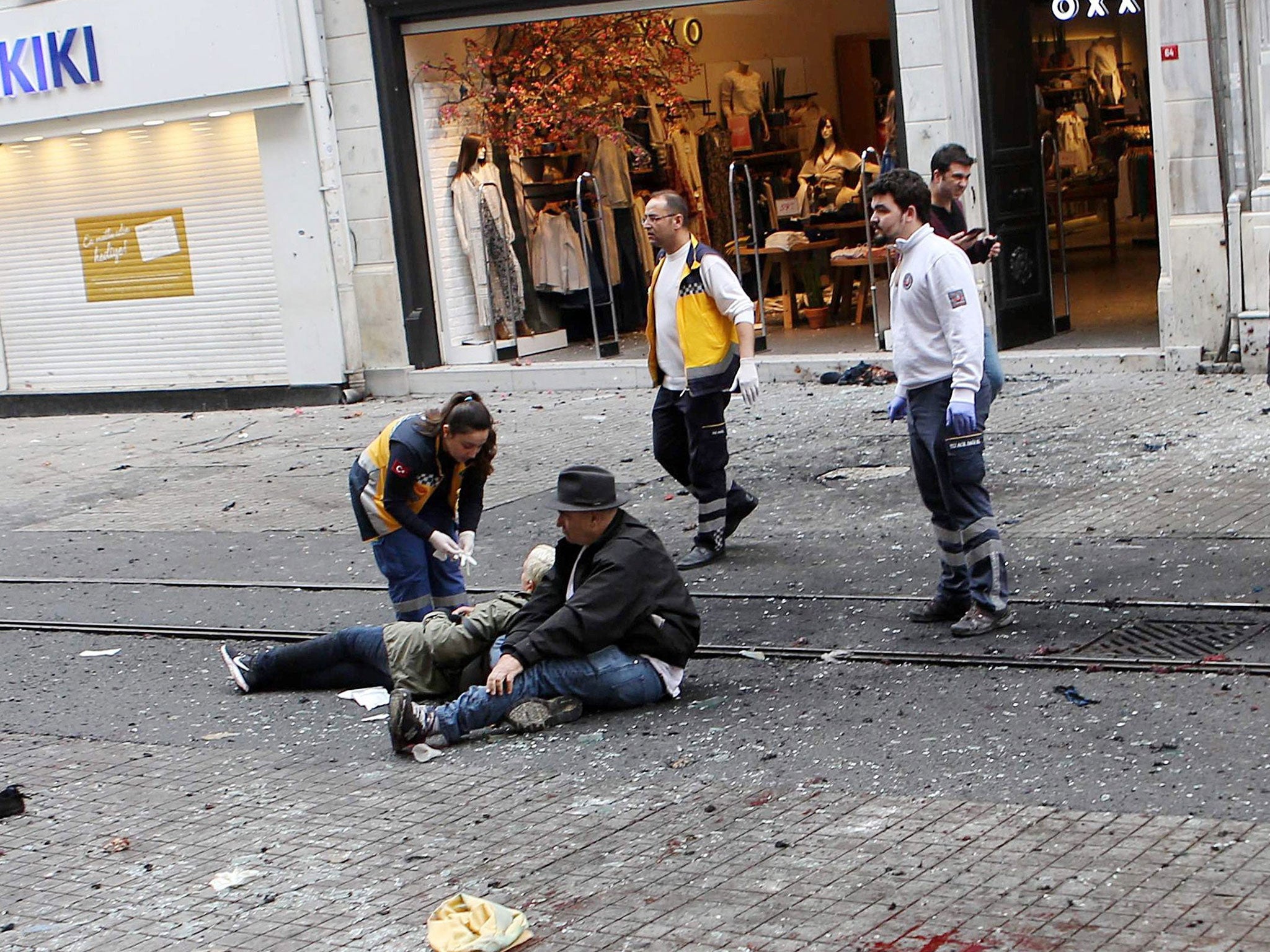 Medics try to help wounded people after an explosion in Istiklal Street in Istanbul, Turkey