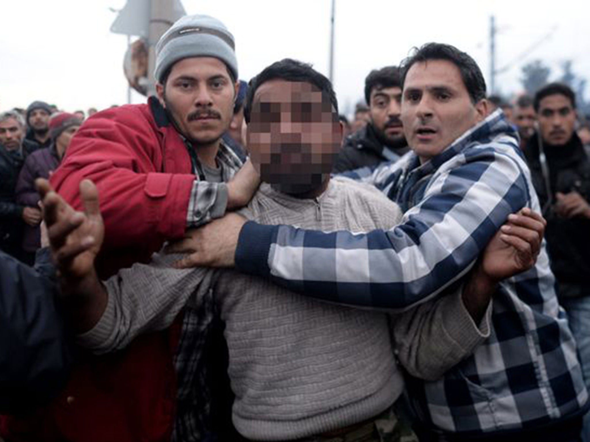 Refugees lead the man through the camp