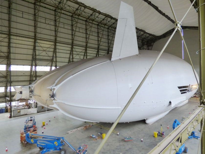 The Airlander 10 - part plane, part airship and part helicopter - in all its 302ft (92m) long glory in a First World War aircraft hangar in Bedfordshire