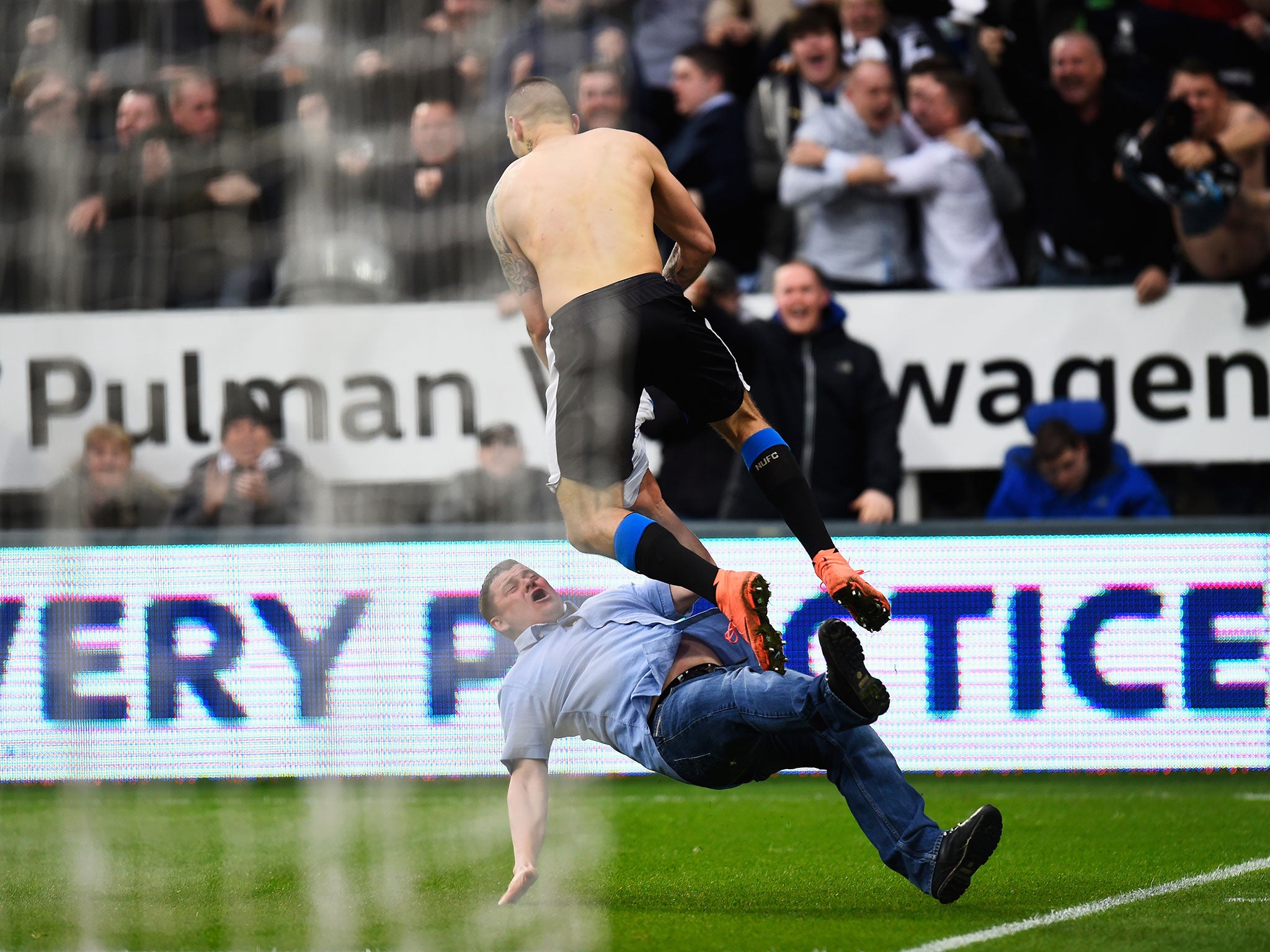 Mitrovic celebrated with a Newcastle fans after heading in the equaliser