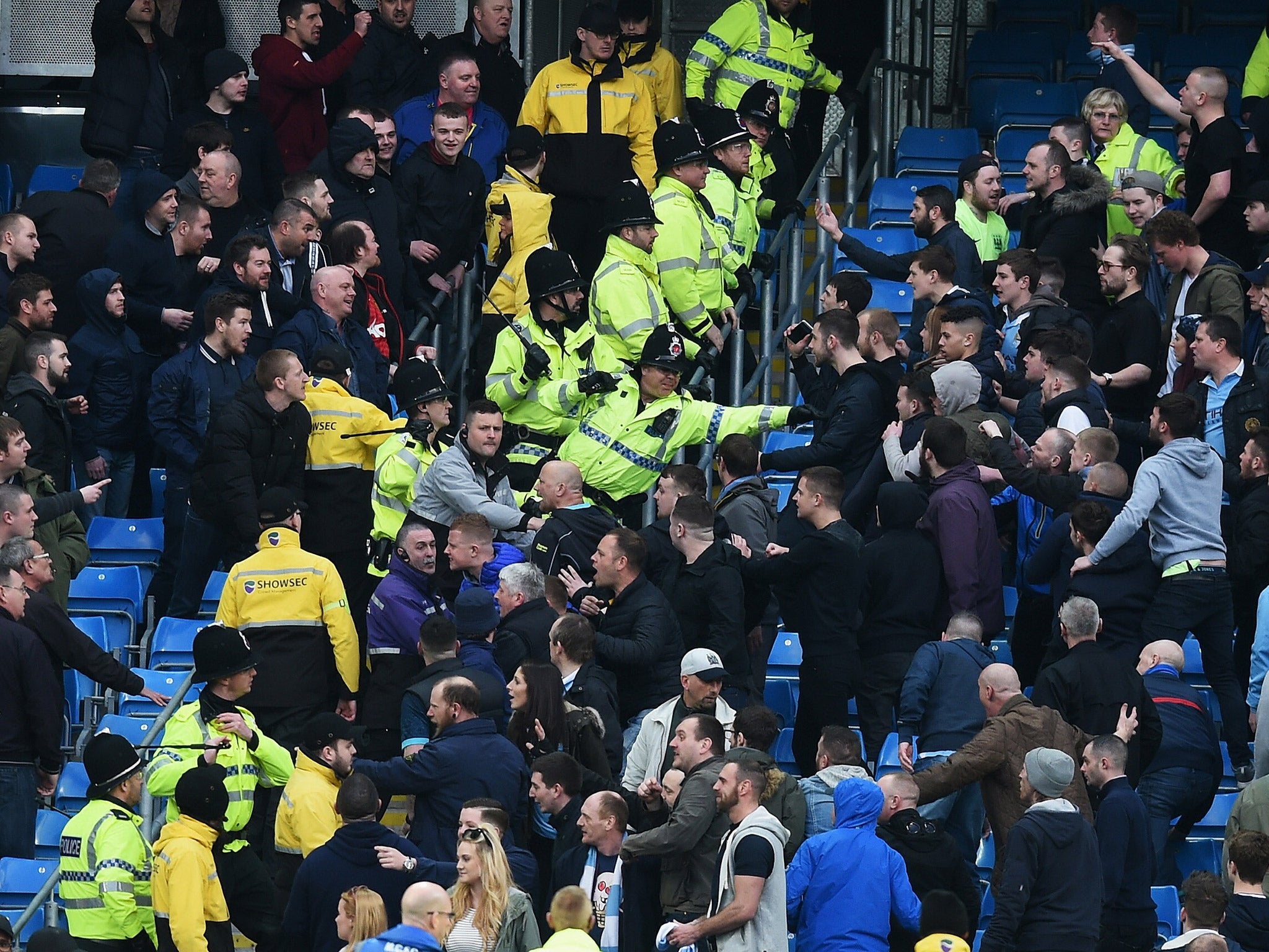 Manchester City and United fans clash as police attempt to separate them during Sunday's Manchester derby