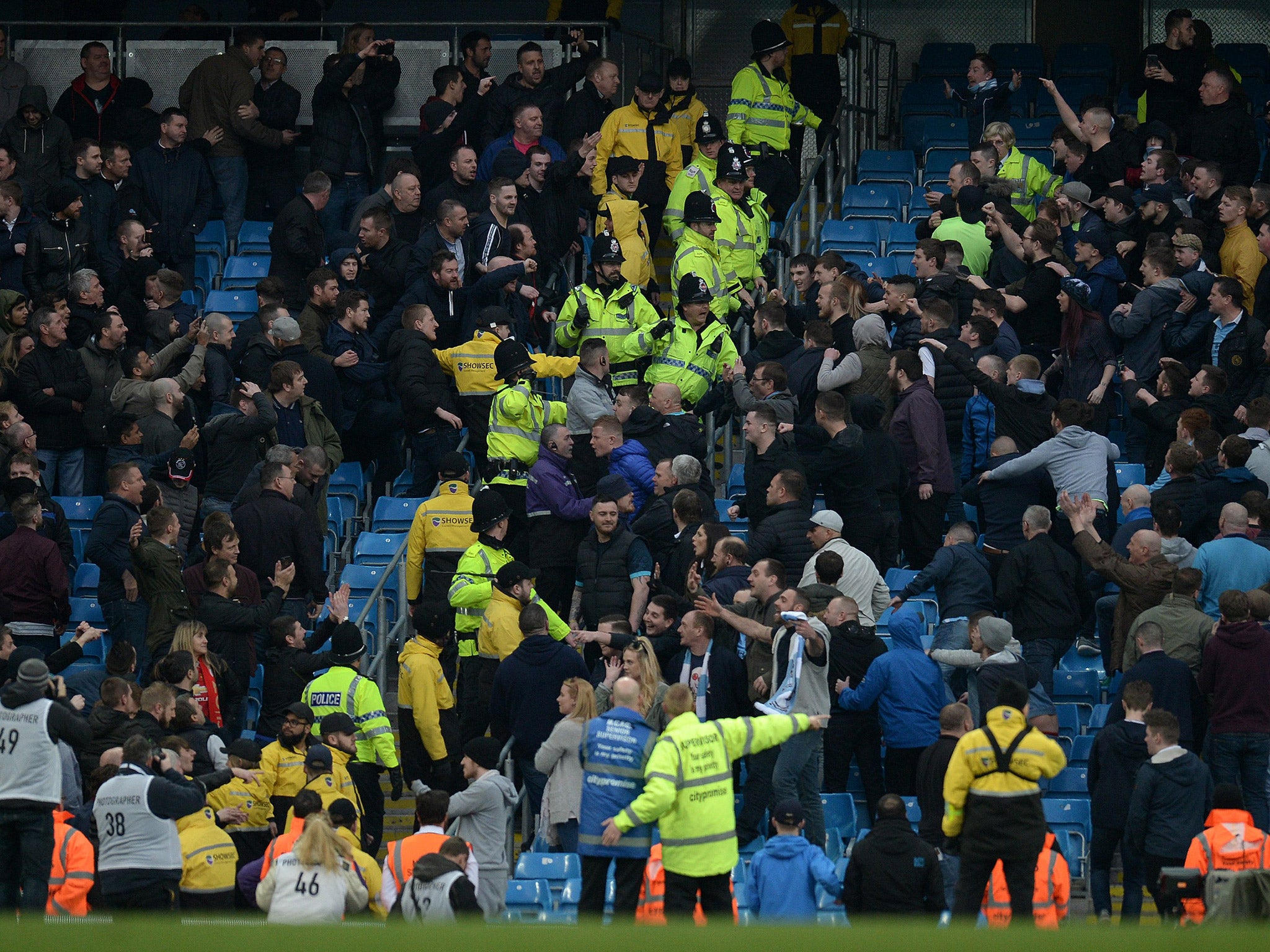 Manchester City and United fans clash as police attempt to separate them during Sunday's Manchester derby