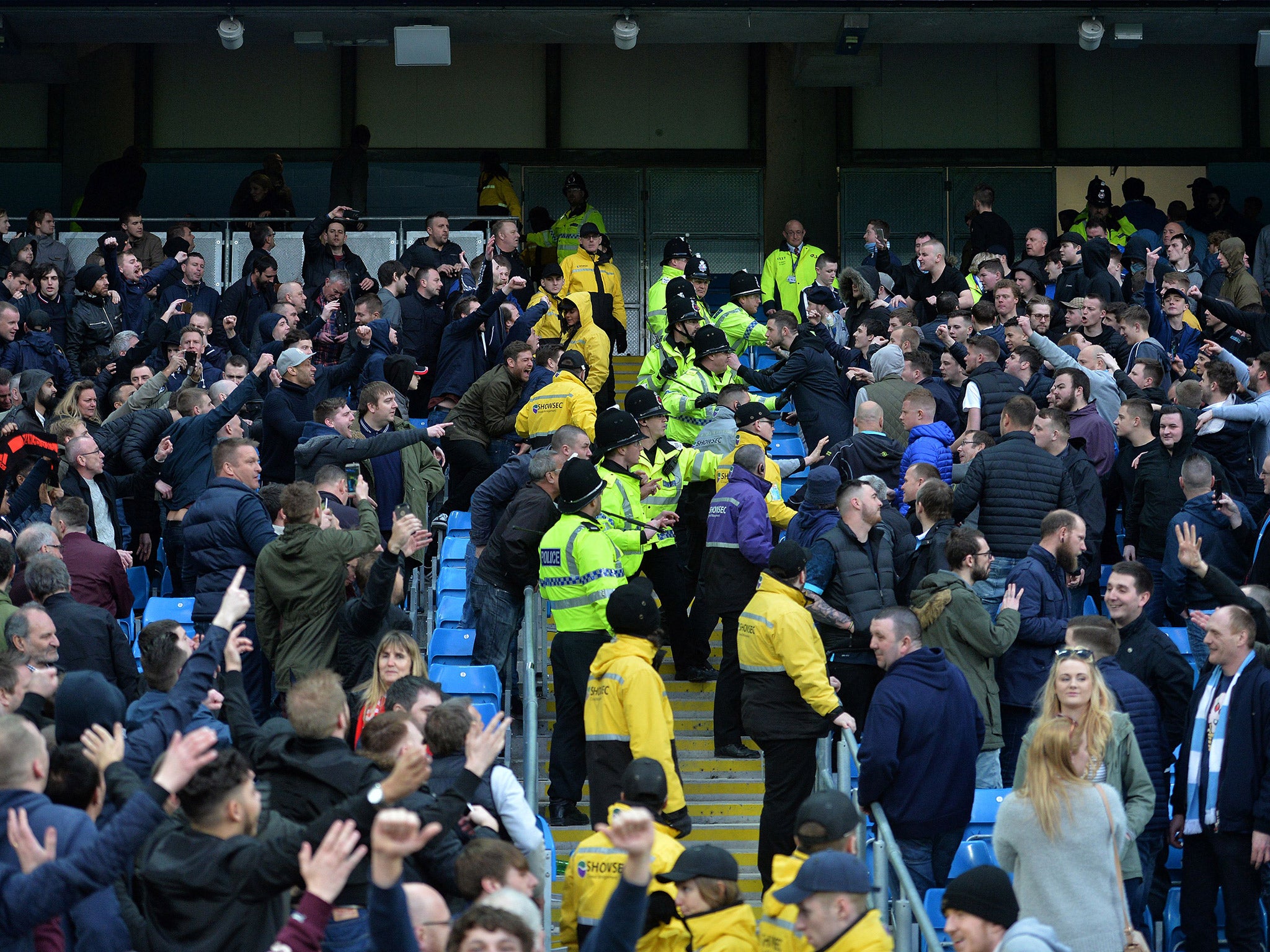 Manchester City and United fans clash as police attempt to separate them during Sunday's Manchester derby