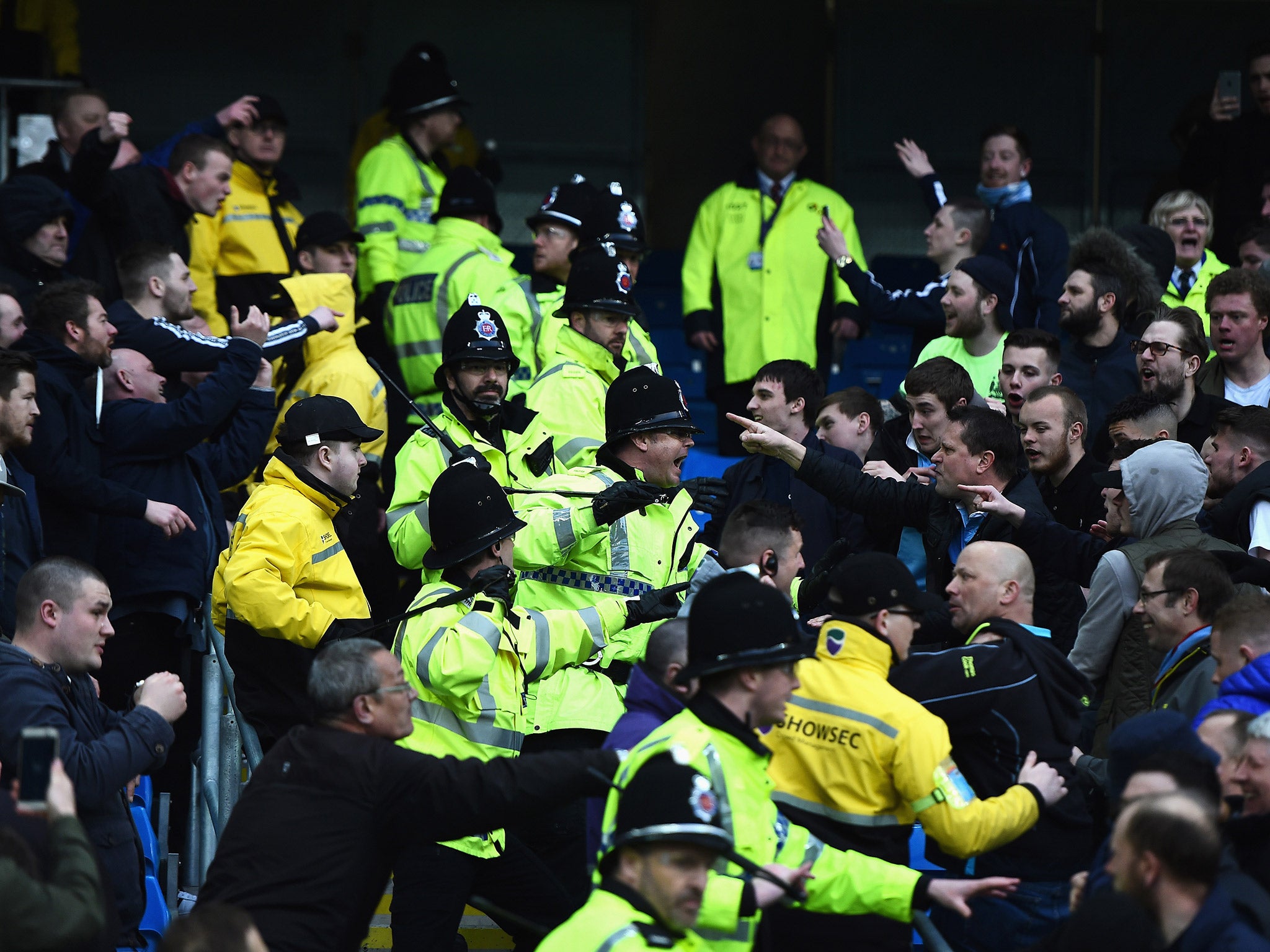 Manchester City and United fans clash as police attempt to separate them during Sunday's Manchester derby