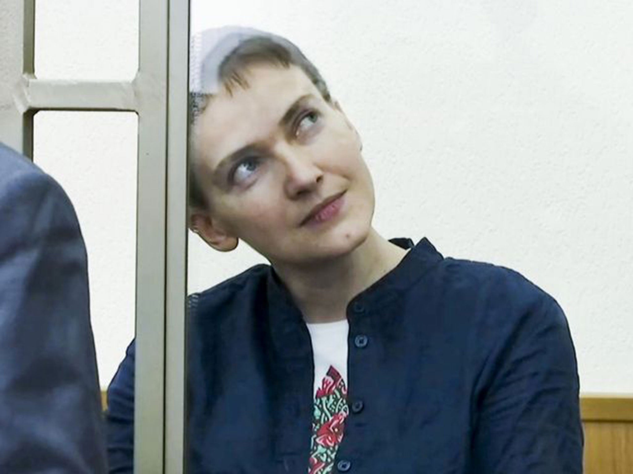 Nadezhda Savchenko sits in a glass cage in court in Donetsk