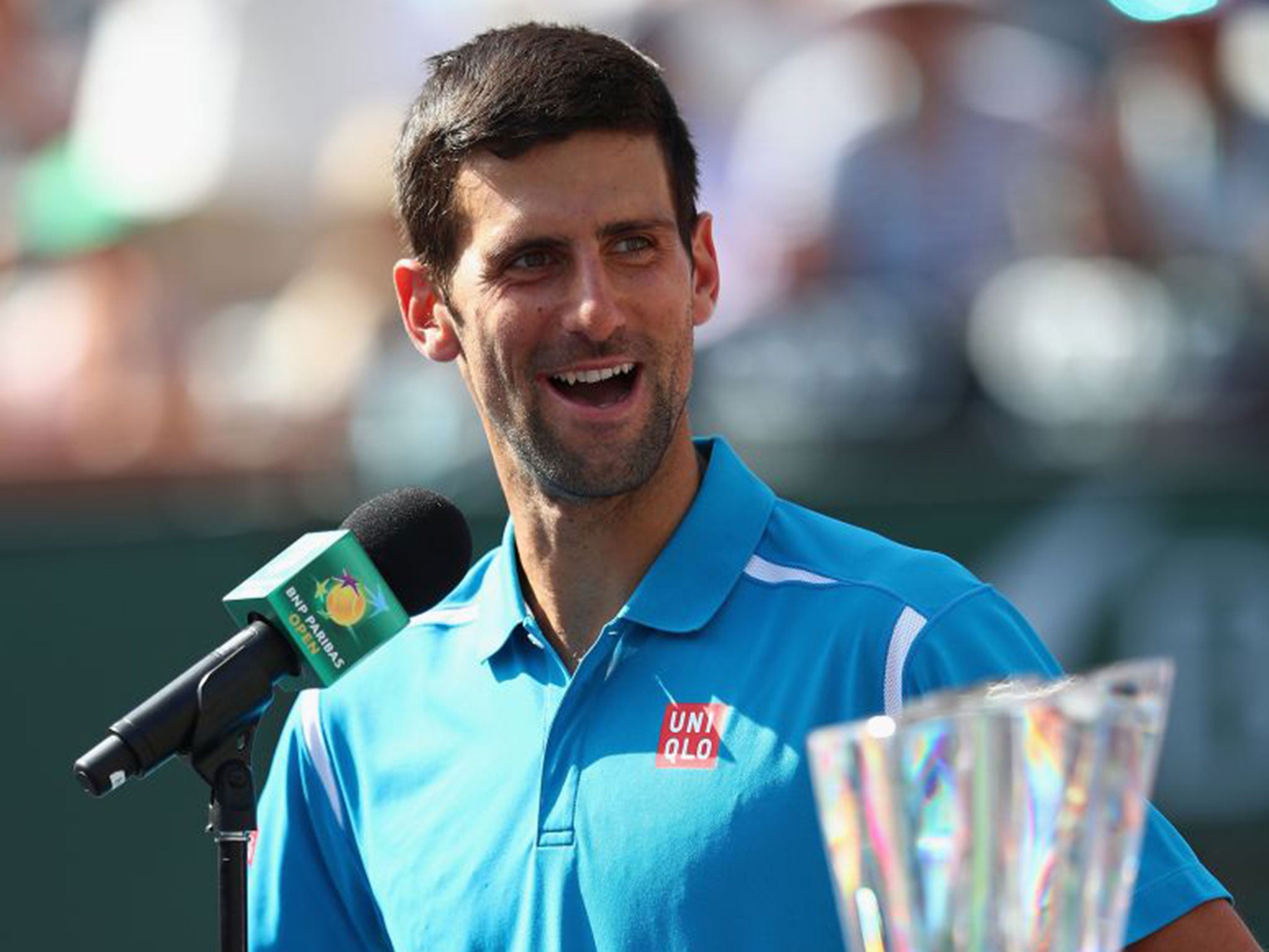 Novak Djokovic talks to the crowd after his win over Milos Raonic at Indian Wells