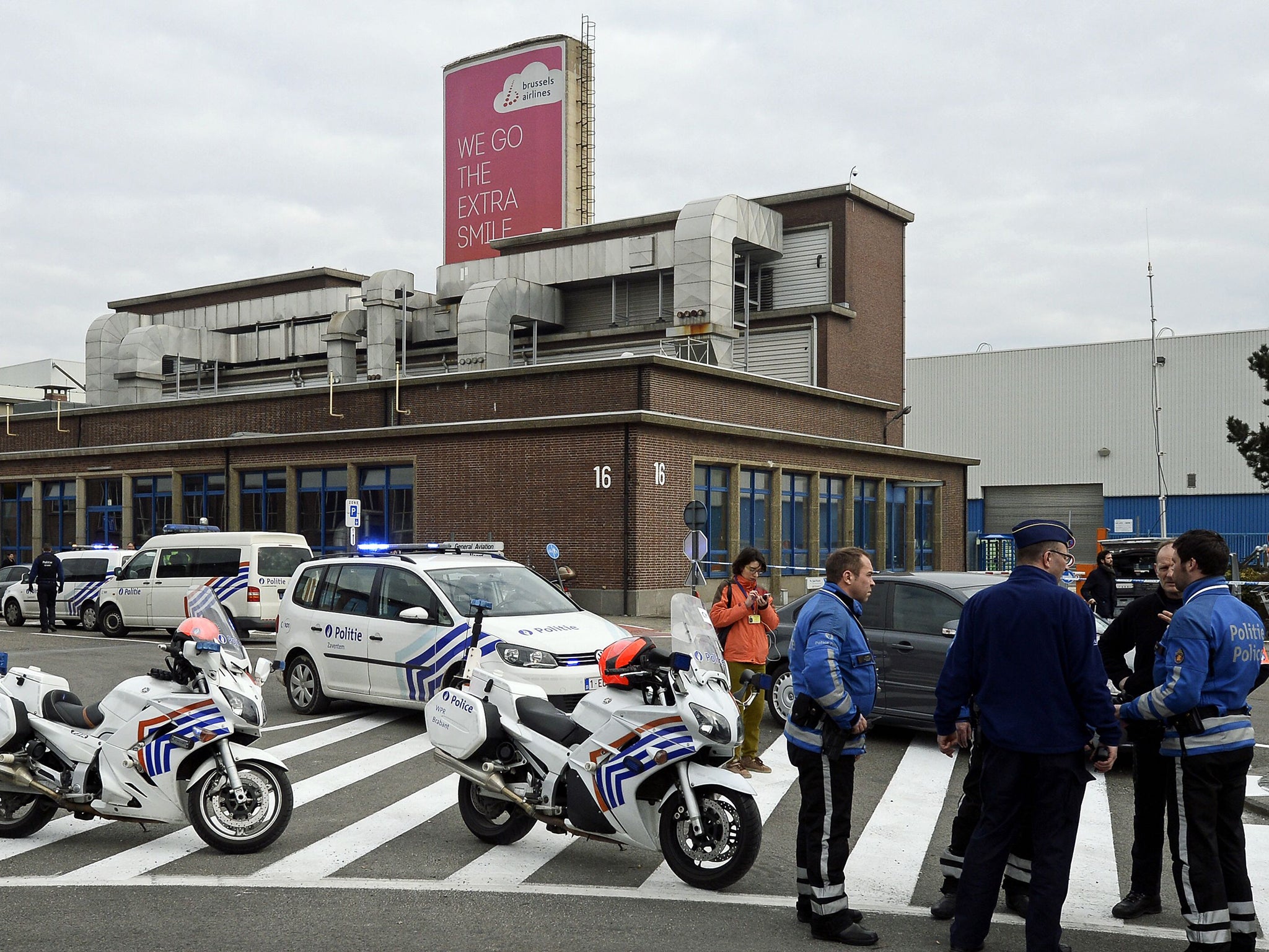 Belgian police officers stand guard at Brussels Airport, in Zaventem,