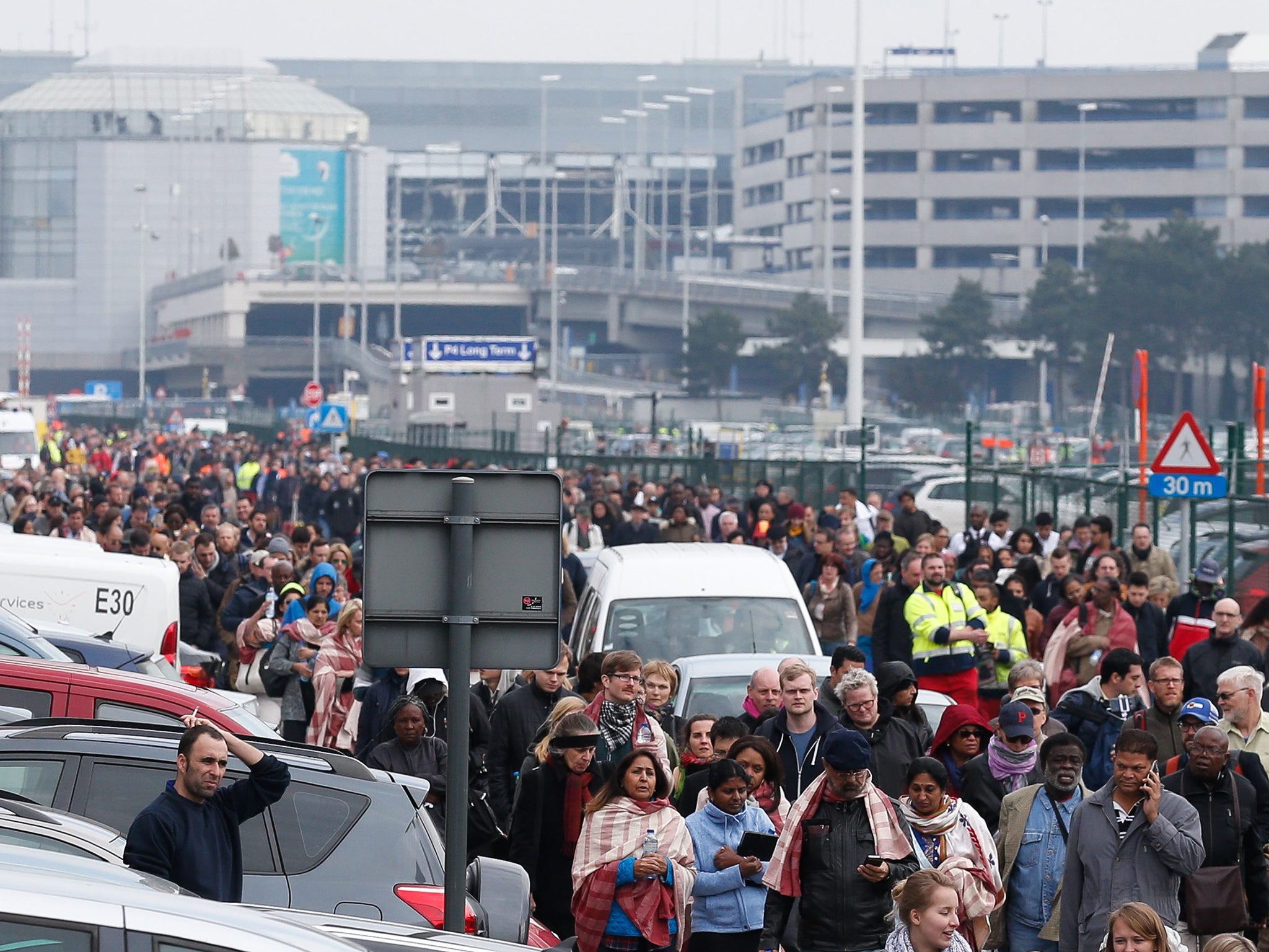 Passengers and airport staff are evacuated from the terminal building after explosions at Brussels Airport in Zaventem near Brussels