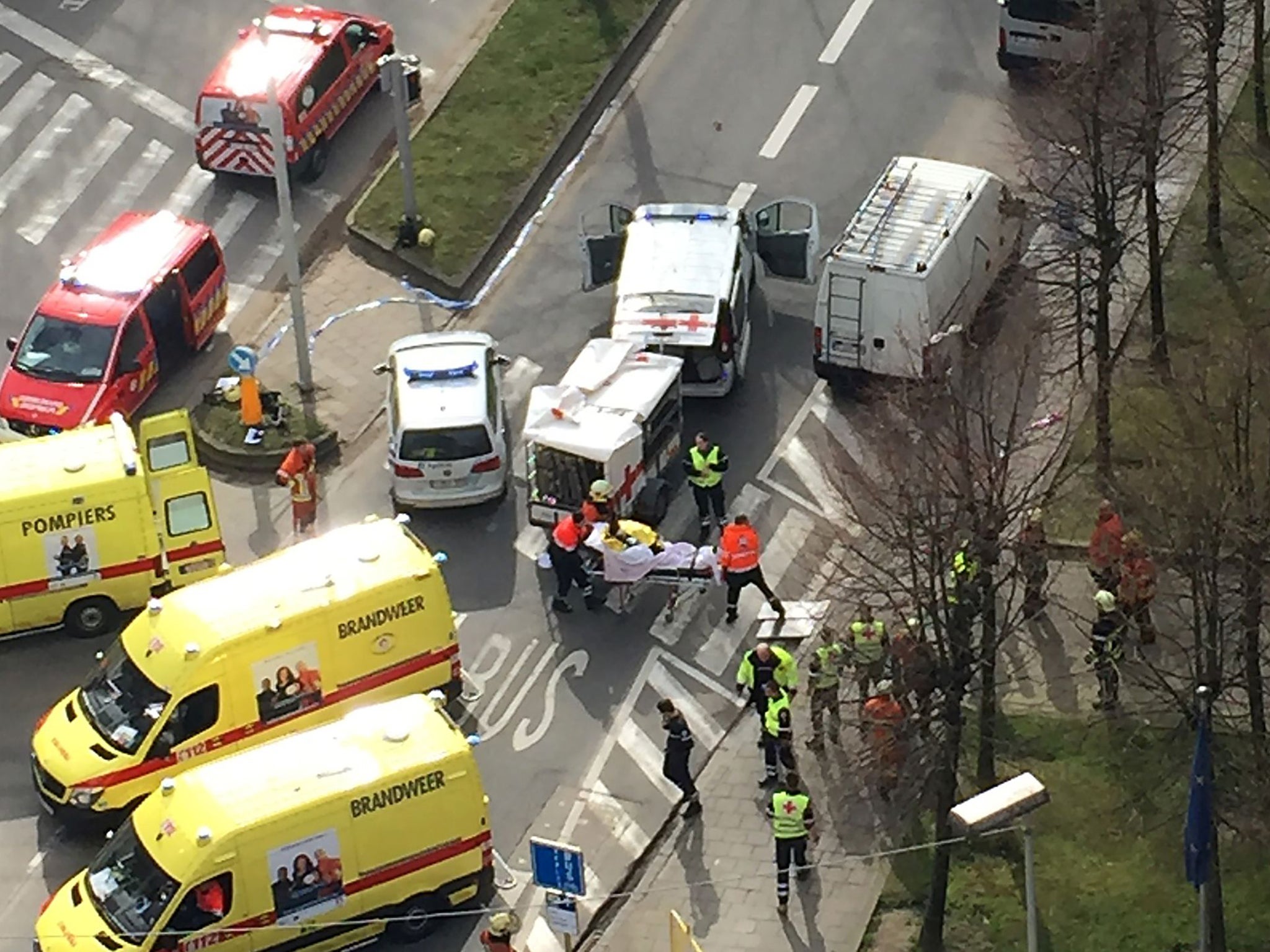 Rescue teams evacuate wounded people outside the Maalbeek metro station in Brussels