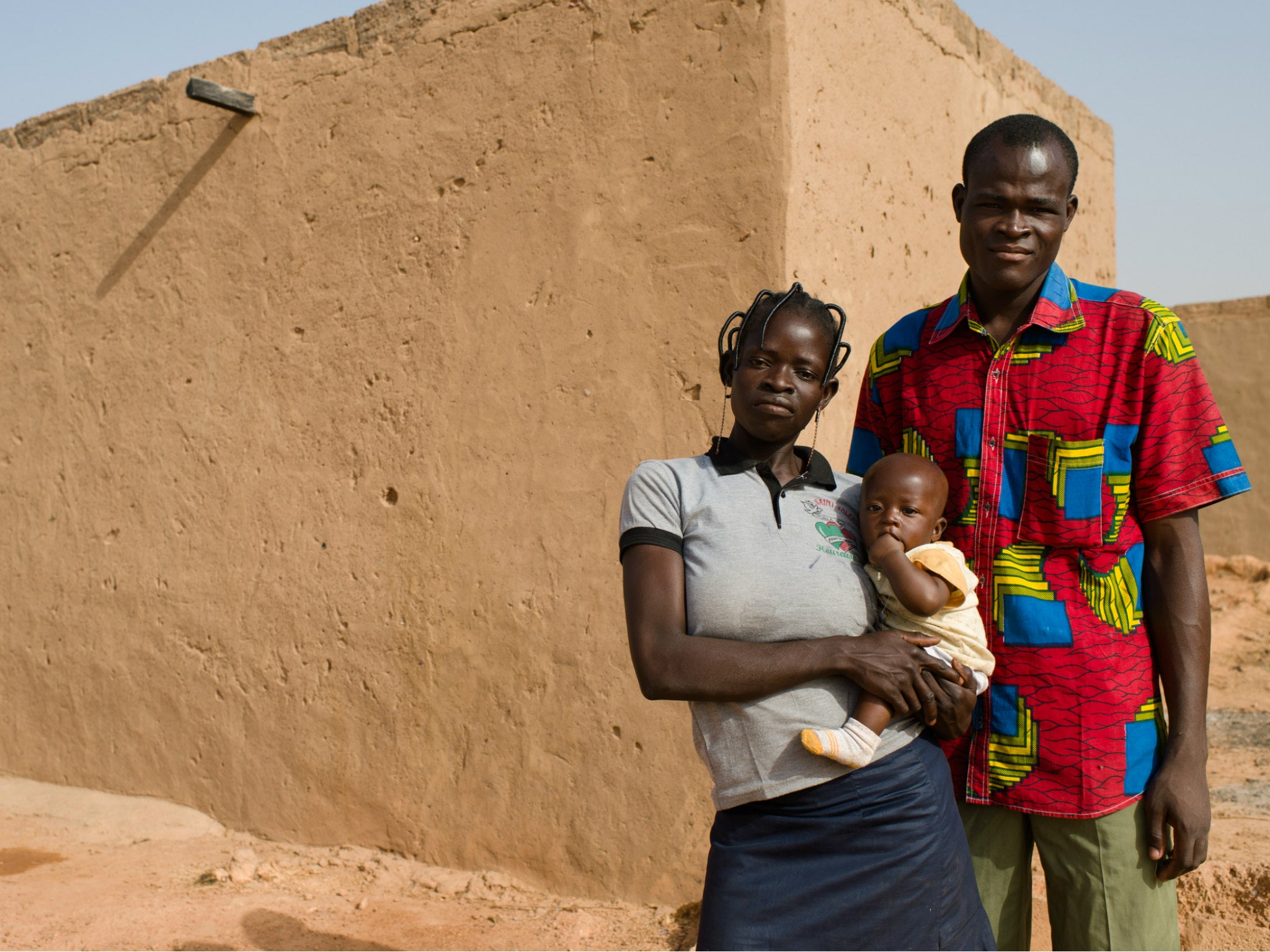 Baowendsom Sama, 22, straps her five-month-old son Isaac to her back as she transports her jerrycan for water and the homemade fanani snacks she sells to earn money for the family in an informal settlement outside Ougadougou, Burkina Faso. Isaac’s twin died of illness a few weeks before. Their water point is 500 metres from home. WaterAid/Eliza Powell