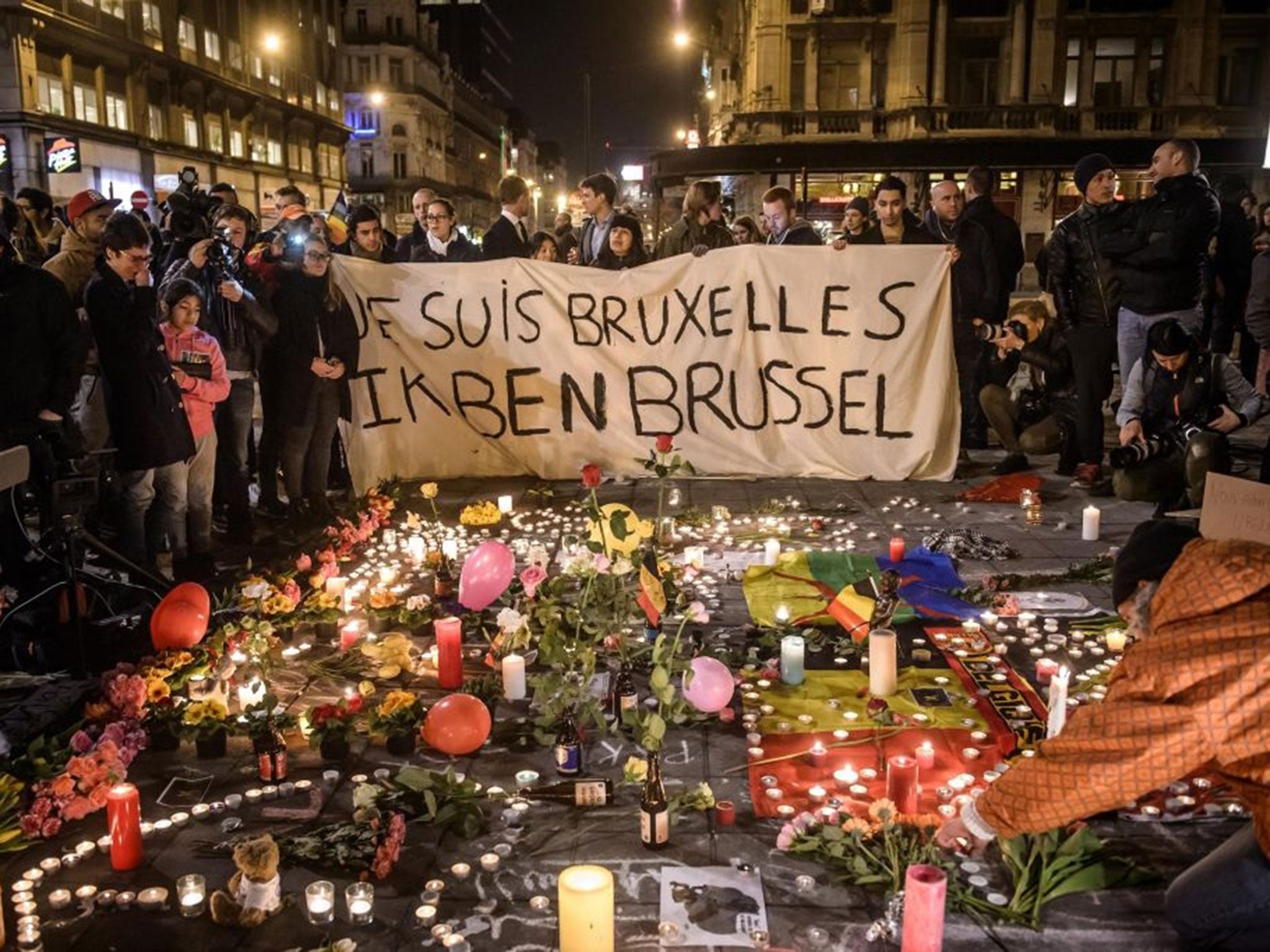 People gather at Bourse square to pay tribute to the victims of the terror attacks that occurred earlier in the day, in Brussels, Belgium, 22 March 2016