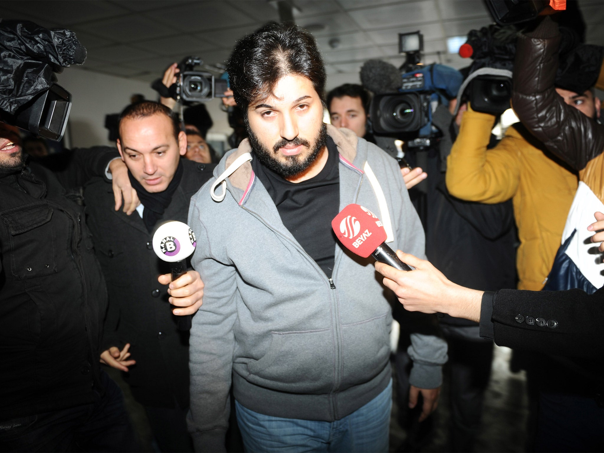 Reza Zarrab is surrounded by journalists at a police station in Istanbul in December 2013, in an inquiry that led to the resignation of three cabinet ministers