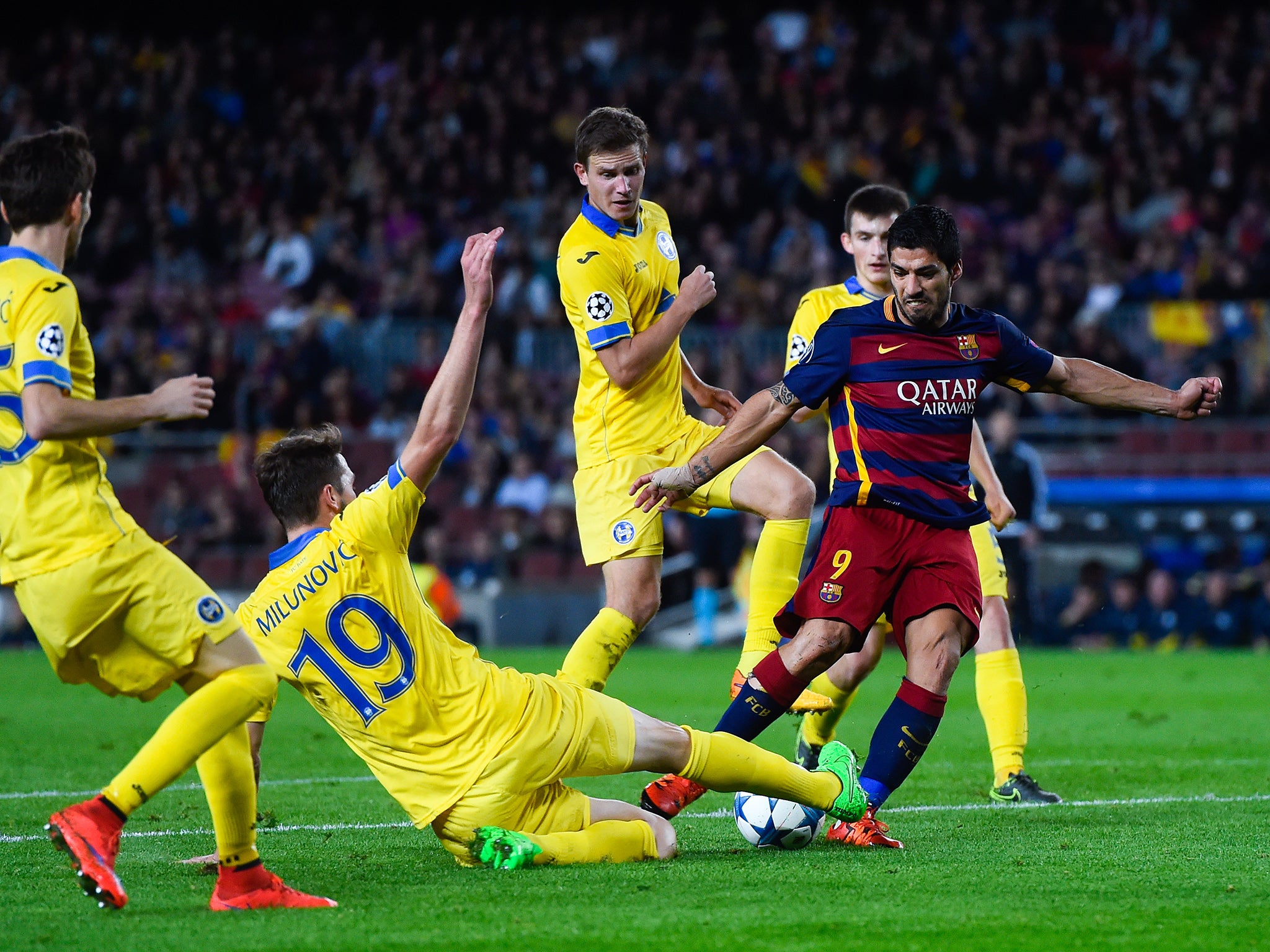 Barcelona's Luis Suarez takes on Nemanja Milunovic of BATE Borisov