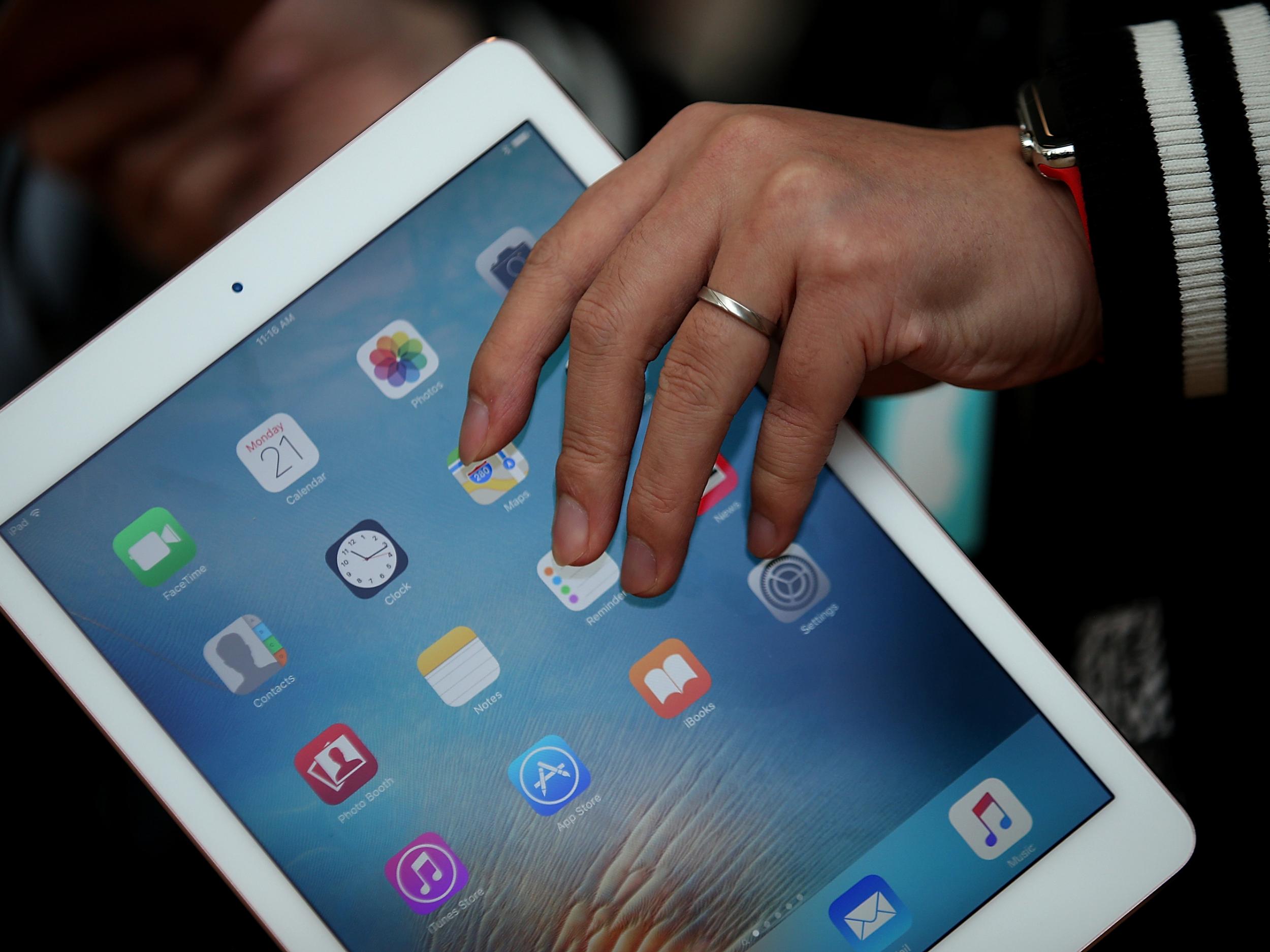 An attendee looks at the new 9.7' iPad Pro during an Apple special event at the Apple headquarters on March 21, 2016 in Cupertino, California