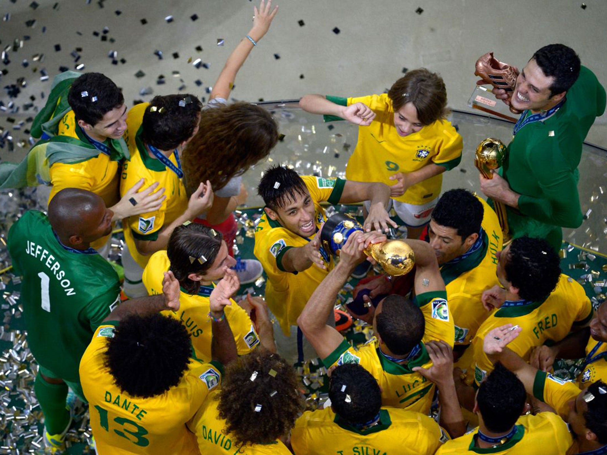 Neymar da Silva Santos, centre, and his Brazilian teammates celebrate winning the tournament in Rio in 2013