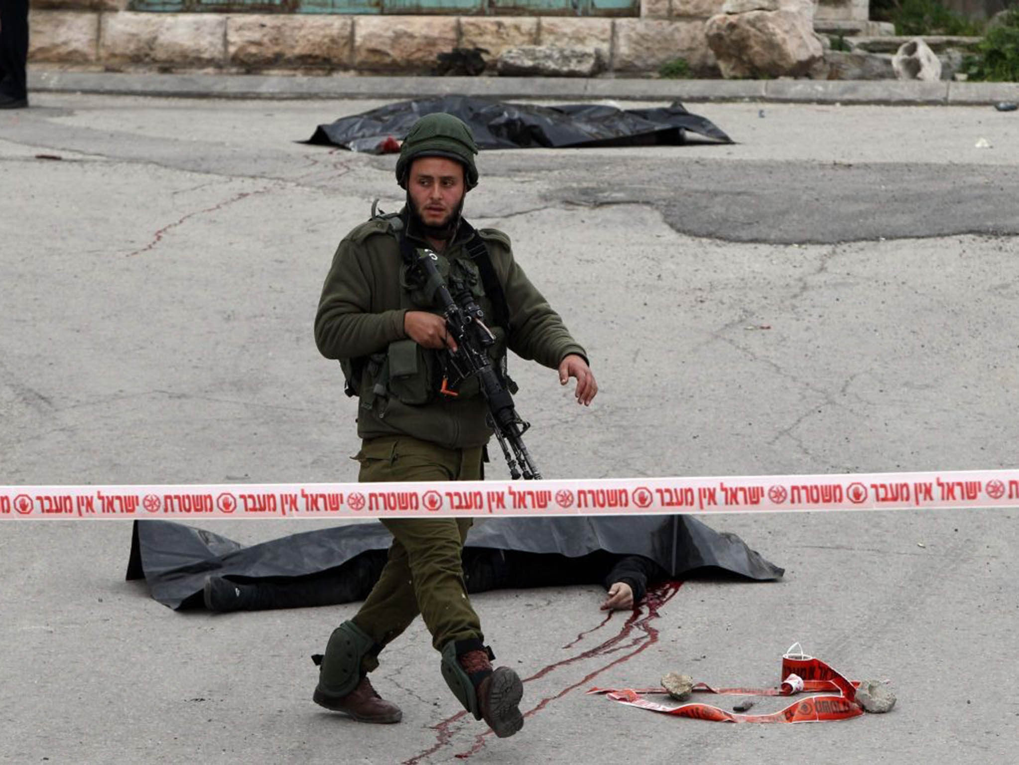 An Israeli soldier at the scene in Hebron