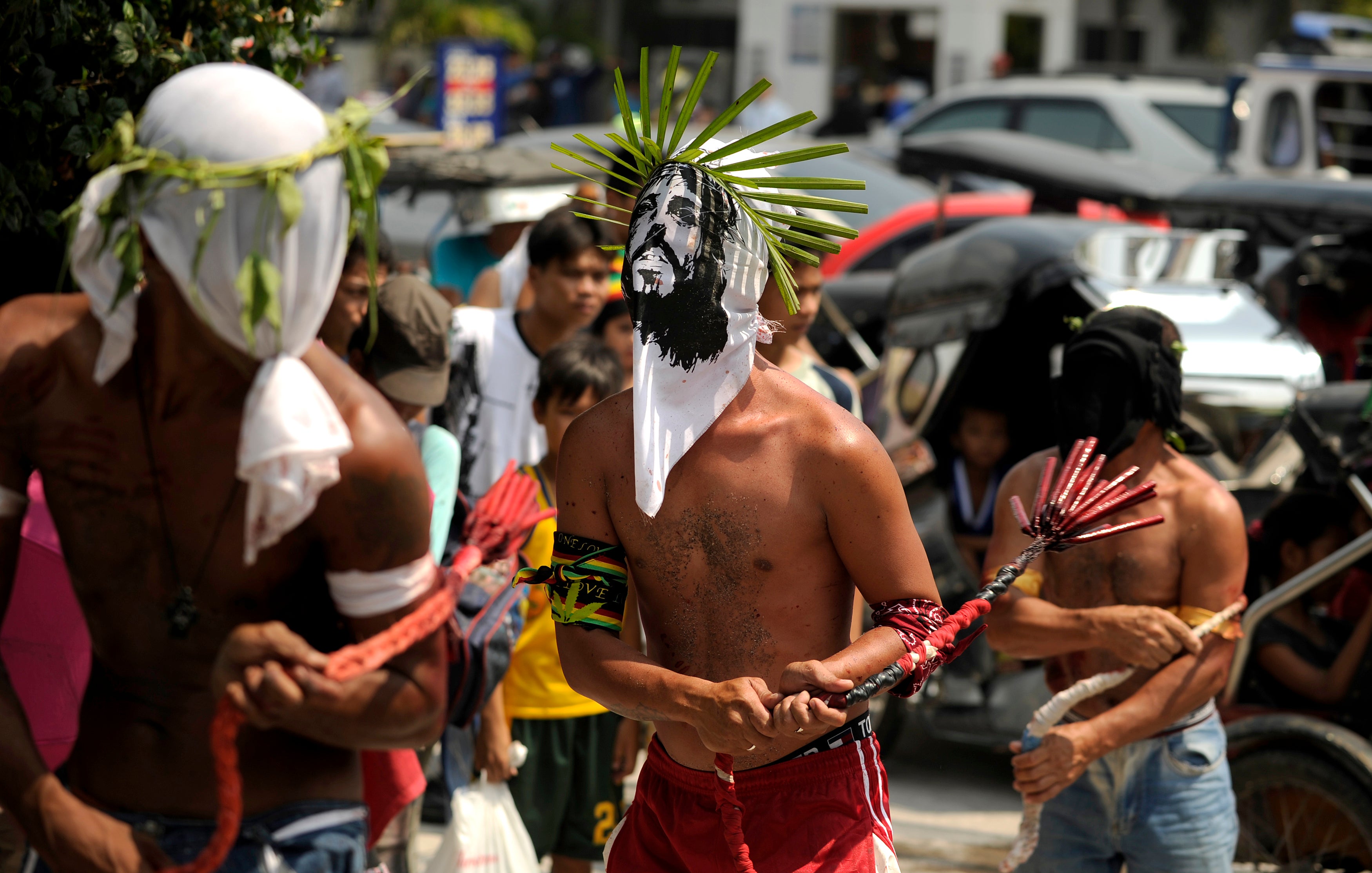 articipants whip their bloodied backs with bamboo as part of their penitence during the re-enactment of the crucifixion of Jesus Christ for Good Friday celebrations ahead of Easter in the village of San Juan.