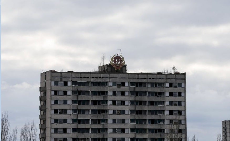 The coat of arms of the former Soviet Union is seen on the roof of a house in Pripyat