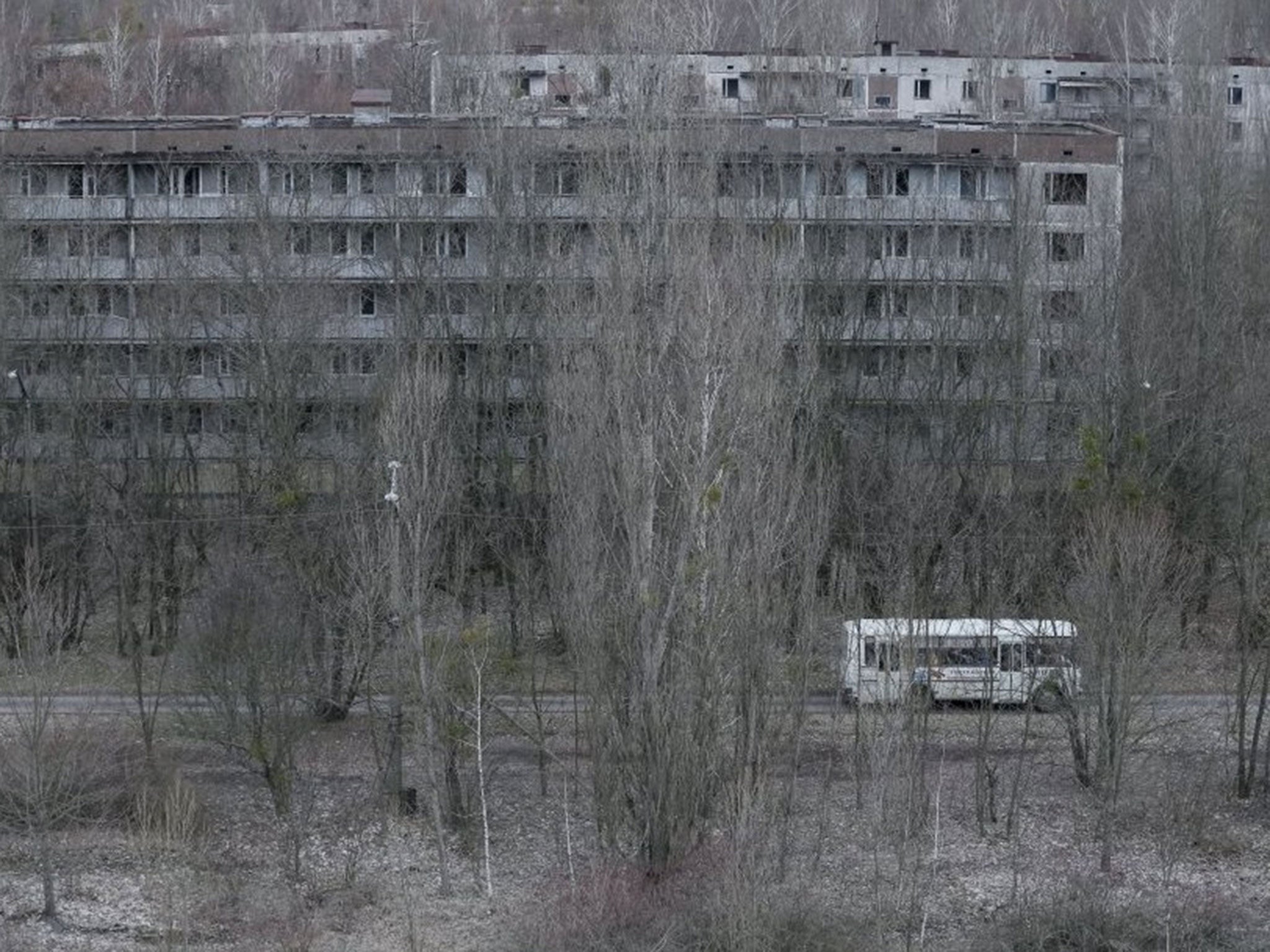 Employees ride in a bus in the abandoned city of Pripyat