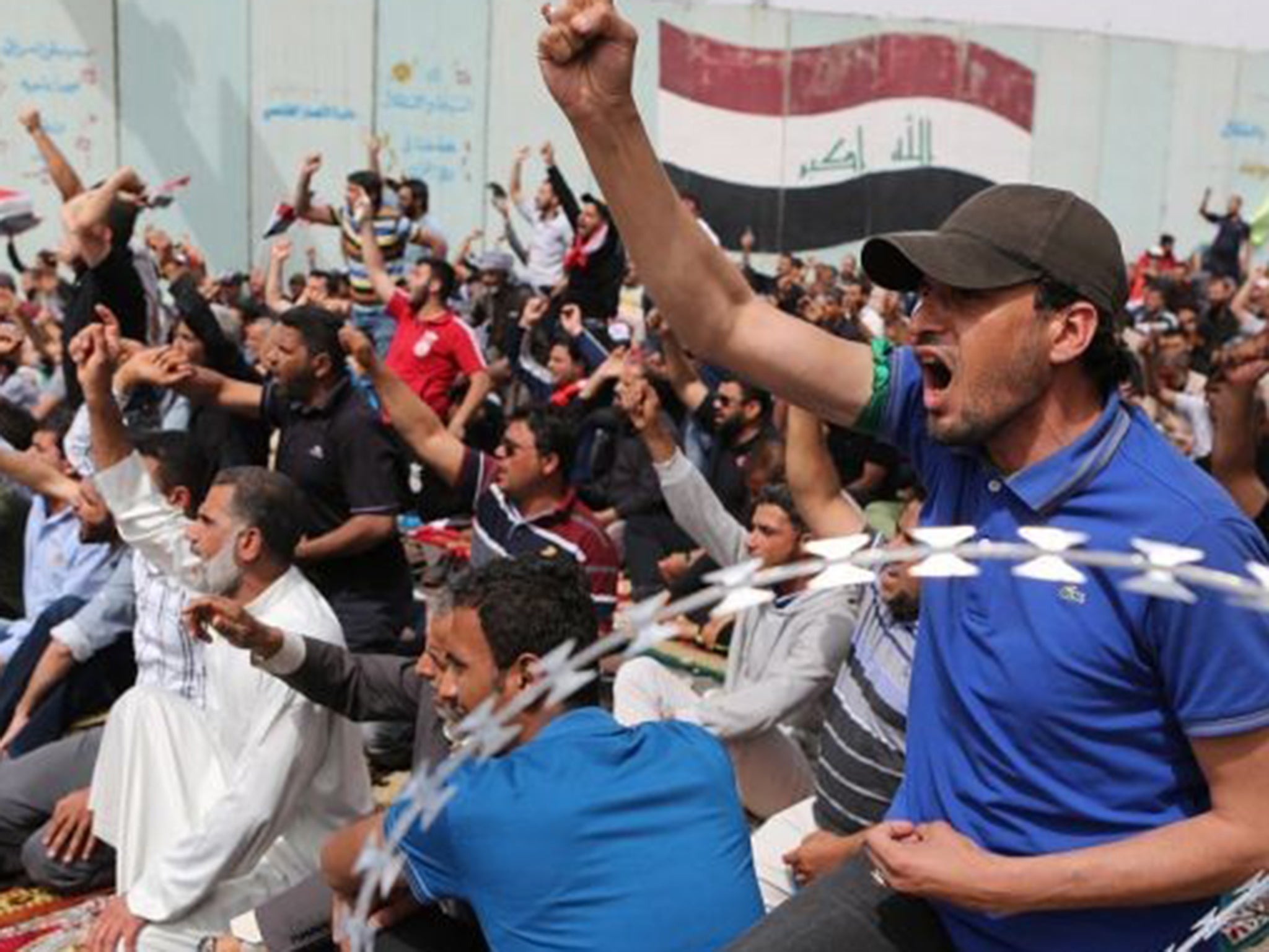 Protesters at one of the entrances to the Green Zone – a fortified area in the centre of Baghdad used by the government – after Friday prayers yesterday