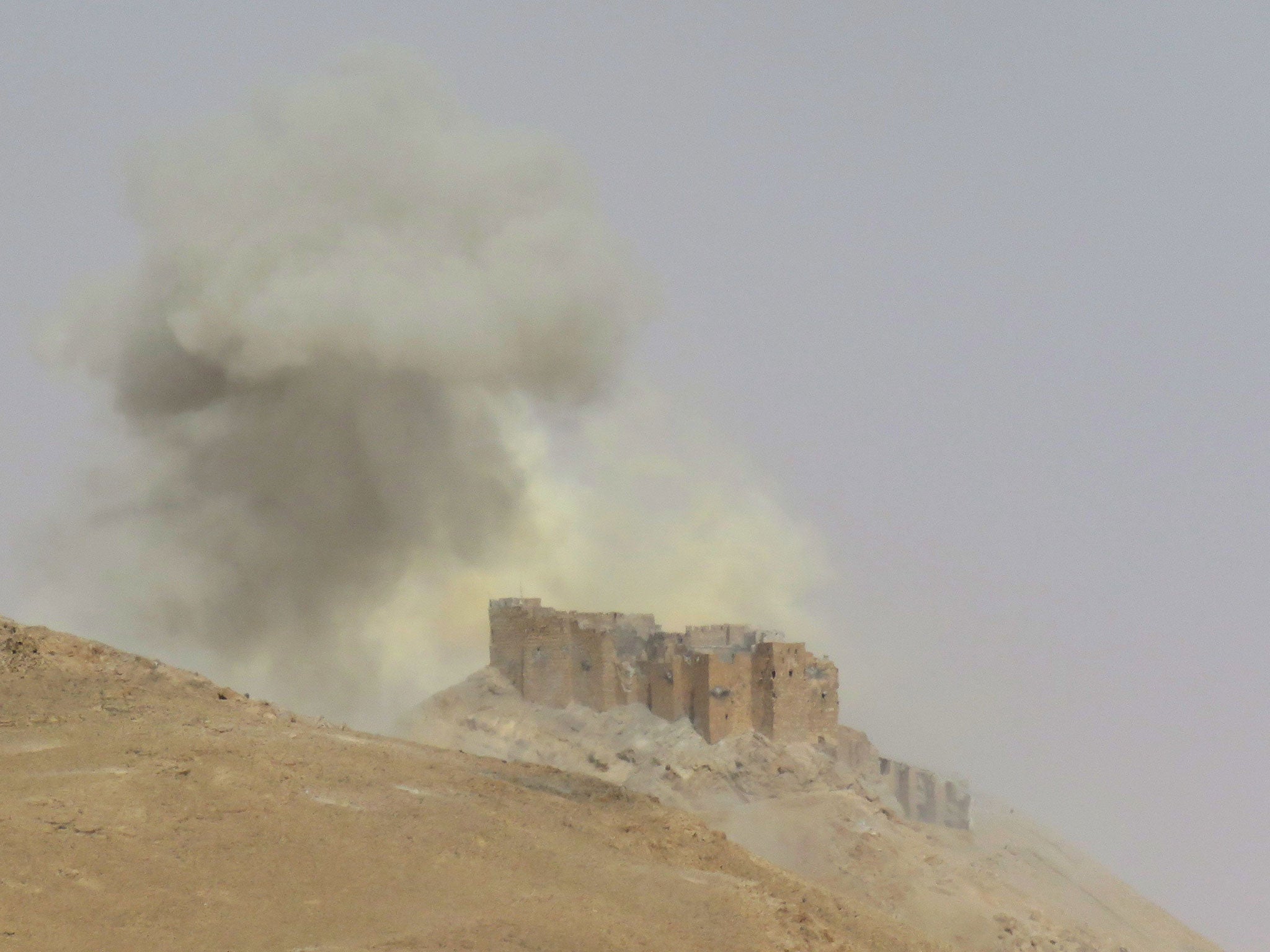 Smoke billows from Palmyra Castle on March 25, 2016, during a military operation by Syrian troops to retake the ancient city from Isis