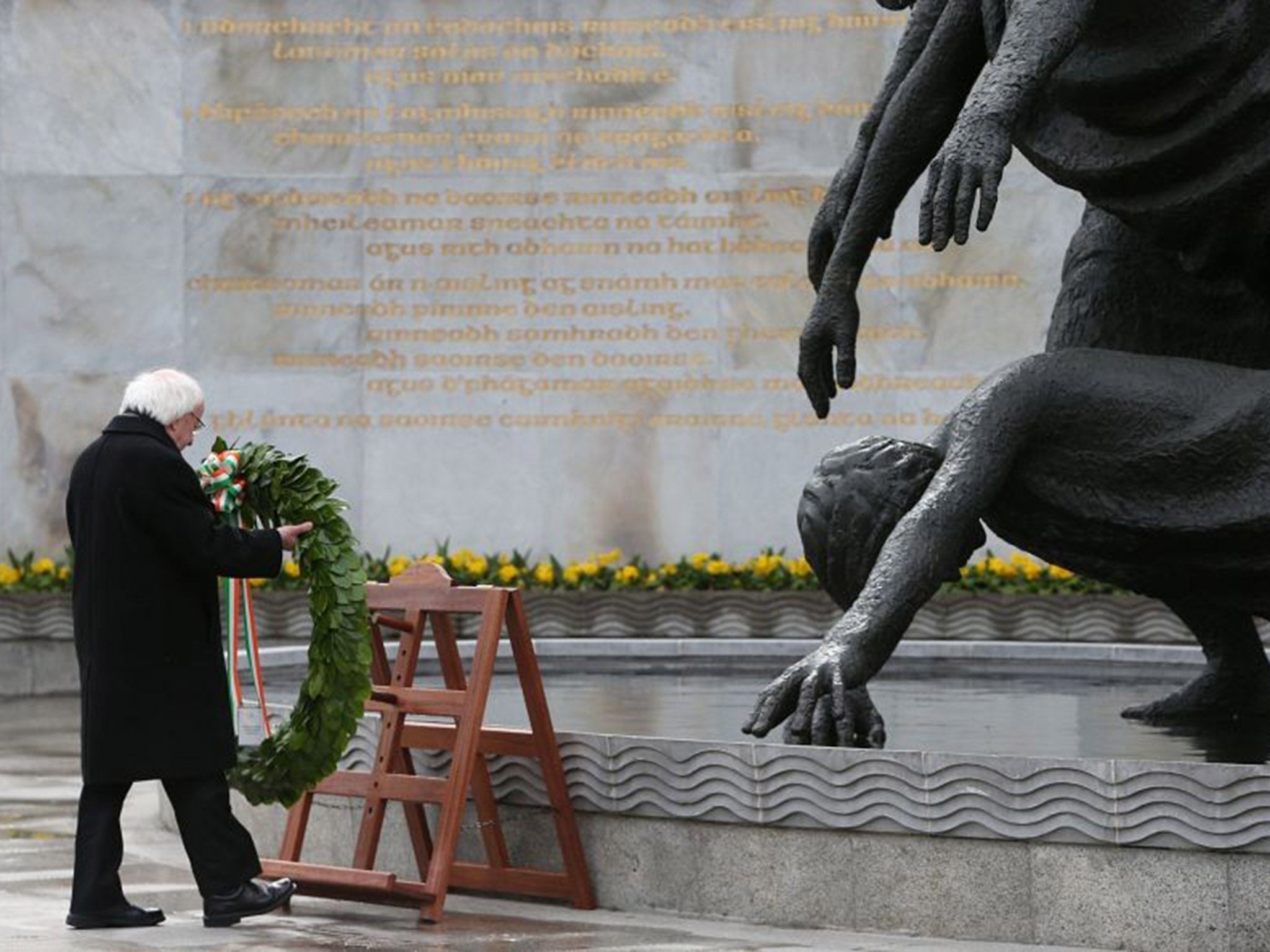 Irish President Michael D Higgins lays a wreath to commemorate the leaders of the 1916 Easter Rising