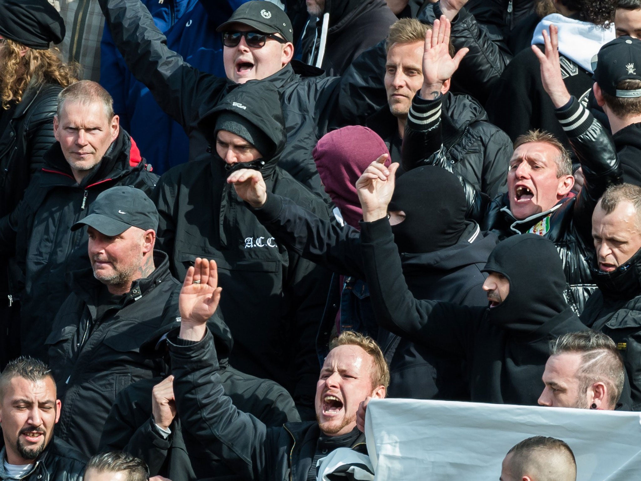 Black-clad protesters shout slogans during the peace vigil