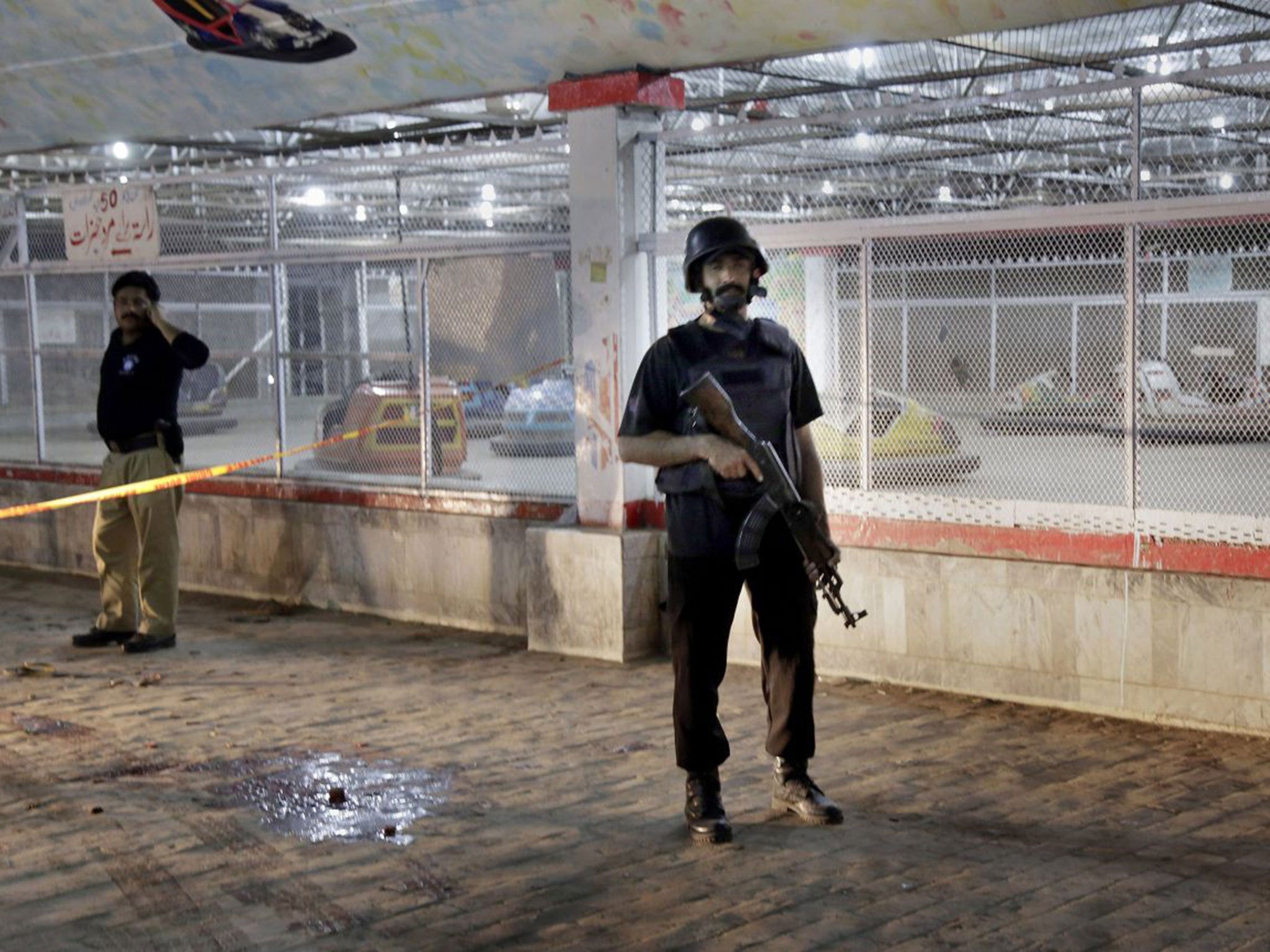 A Pakistani police officer stationed outside the park following the blast