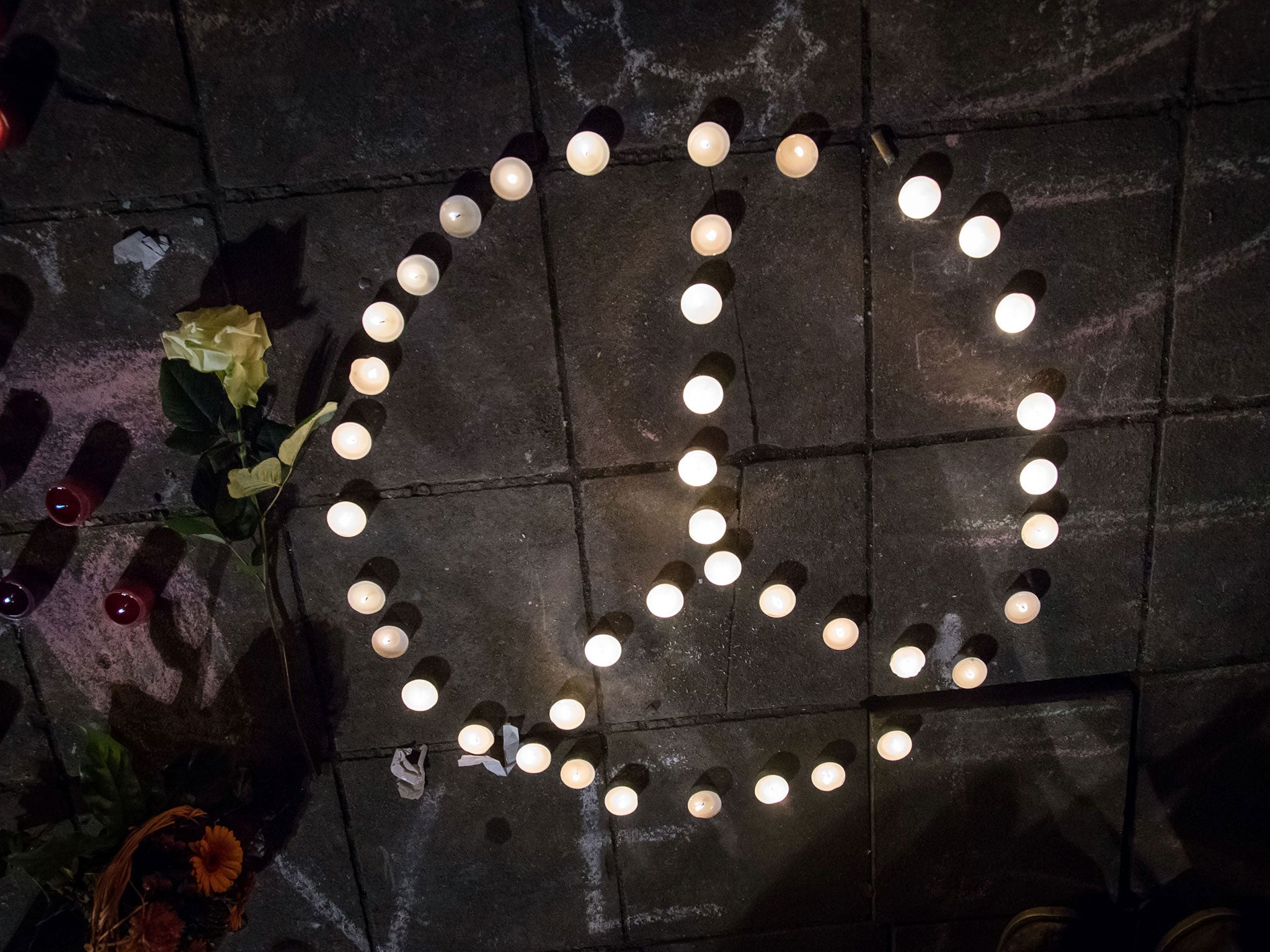 A peace sign made of candles in front of the Bourse of Brussels in tribute to the victims of a triple bomb attack in the Belgian capital that killed about 35 people and left more than 200 people wounded