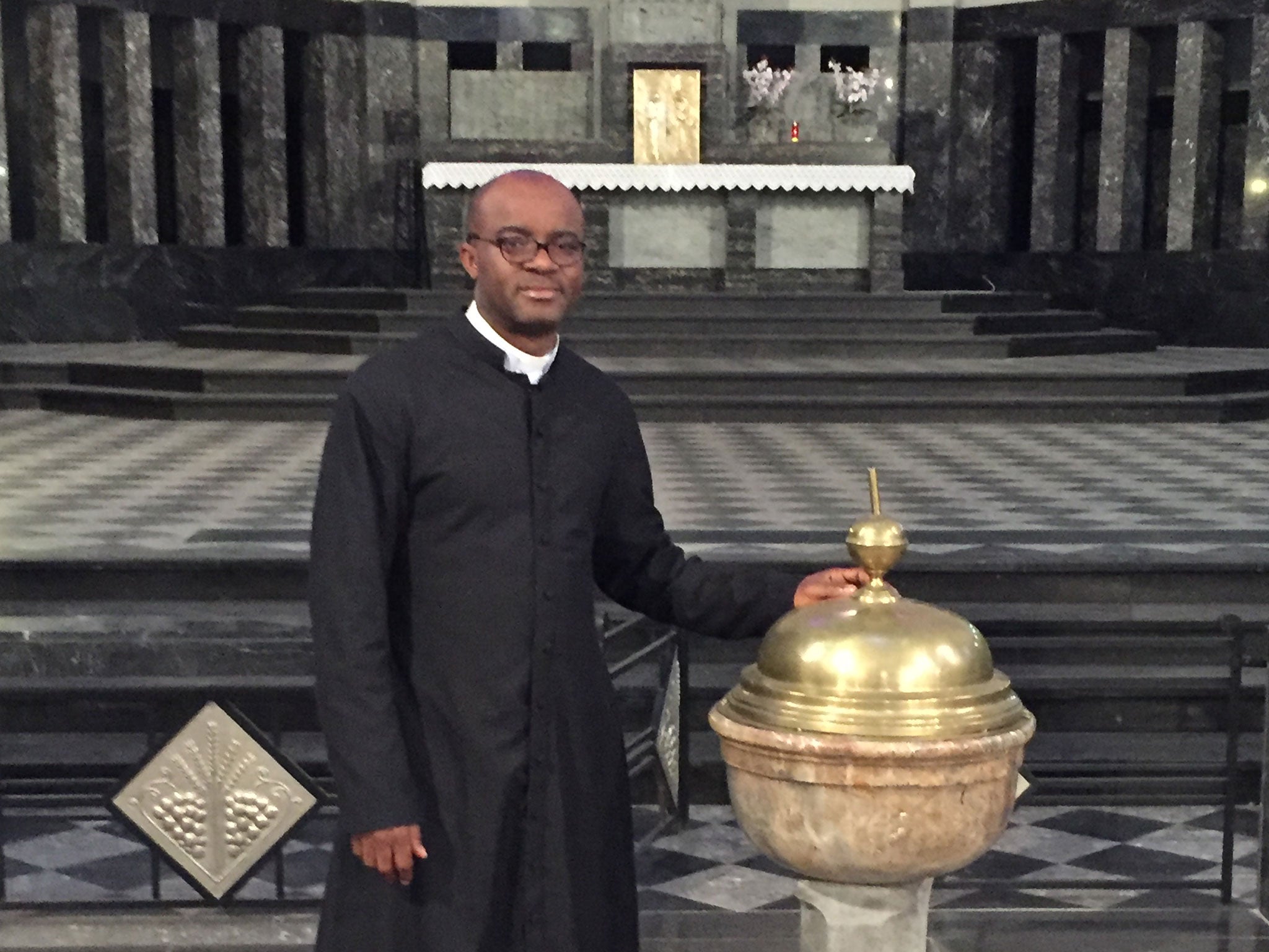 Father Aurelian Saneko preparing for an Easter service