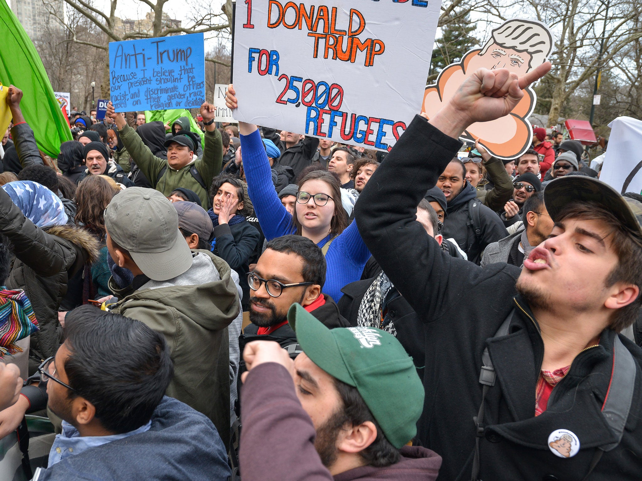 Anti-Trump demonstrators chant as they confront police officers at Sixth Avenue and Central Park South