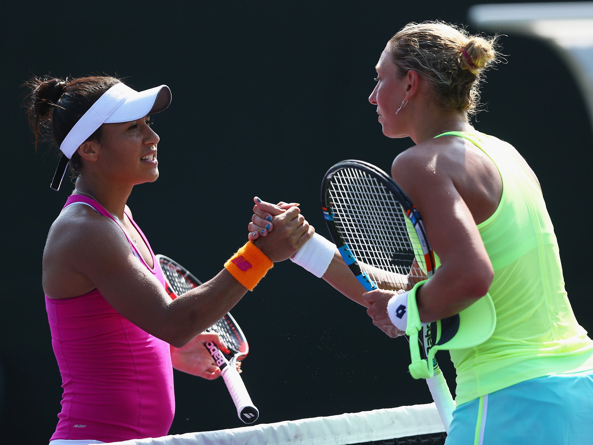 Heather Watson shakes hands at the net after her three set victory