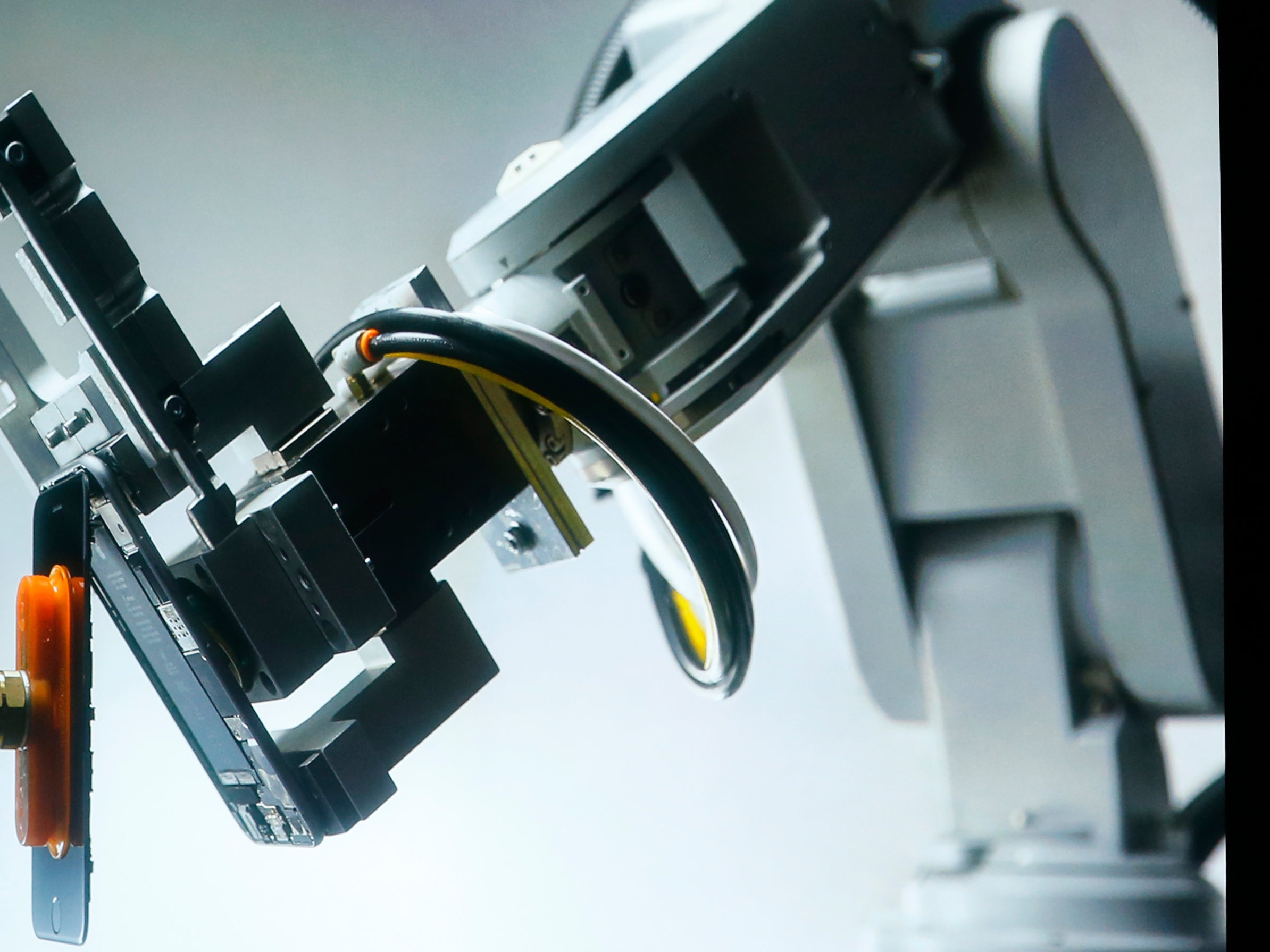 A robot named Liam that deconstructs iPhones is shown during an event at Apple headquarters, where it also announced the release of iOS 9.3