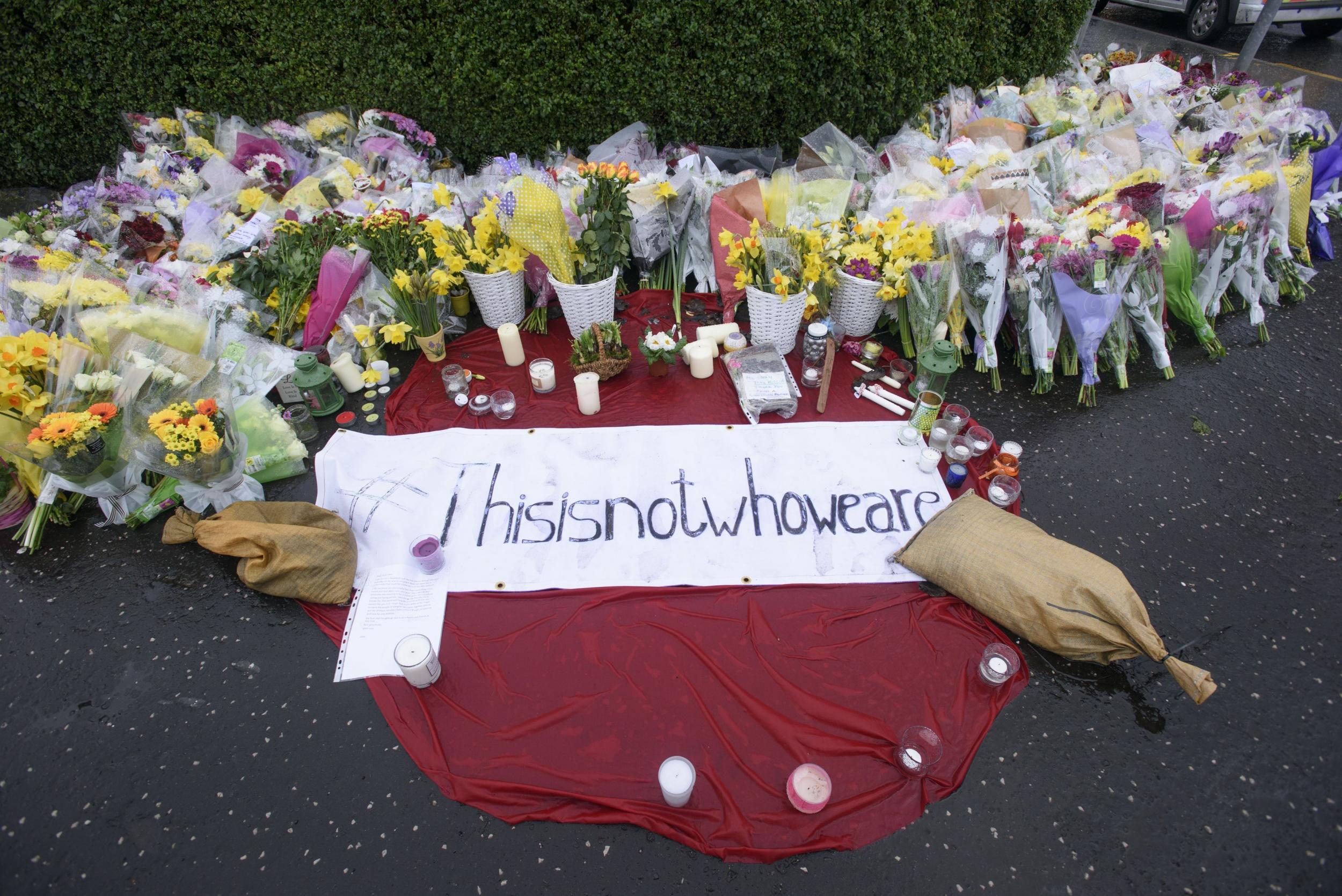 Tributes left to Asad Shah outside his shop in Shawlands, Glasgow